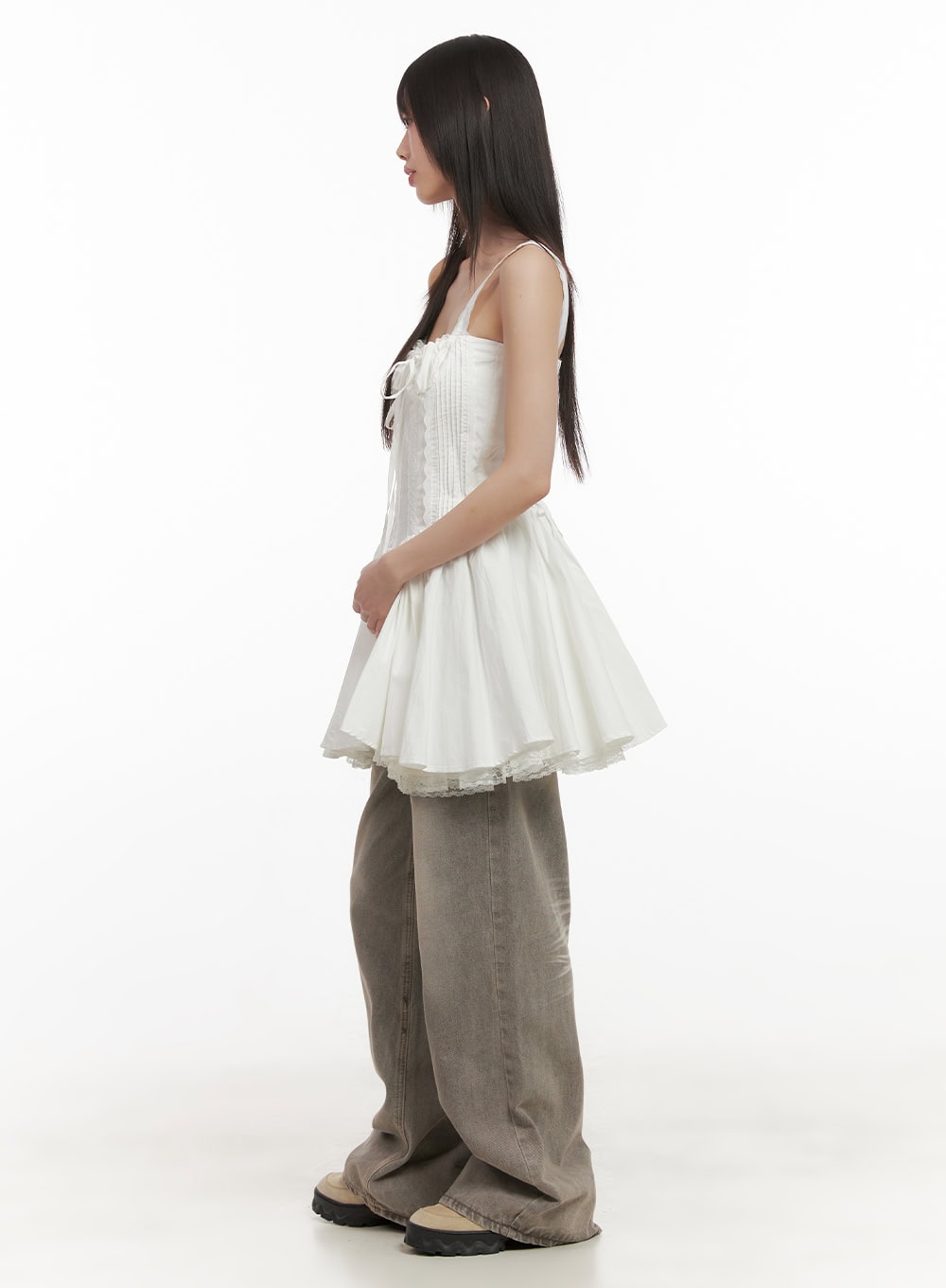 Hollie Vintage Wide-Leg Jeans CD426 in gray, side view on model, baggy wide-leg washed denim showing leg silhouette, styled with white ruffled corset cami top and chunky sneakers.