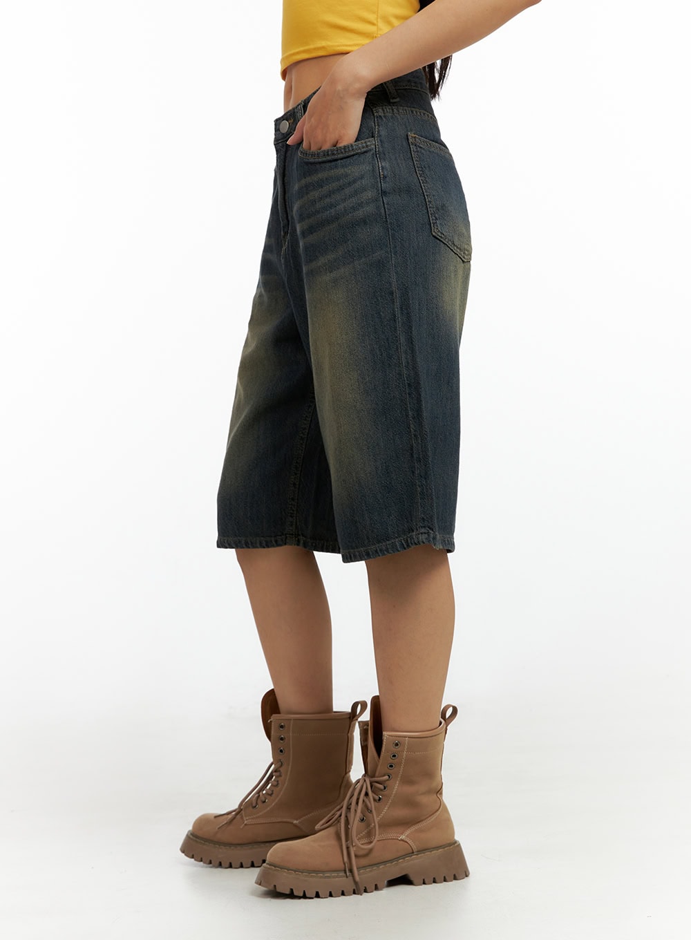Dark Washed Wide Leg Jorts IL419 in dark blue, close-up side view highlighting wide-leg cut, vintage dark wash with golden fading, side pocket detail, and raw hem above combat boots.