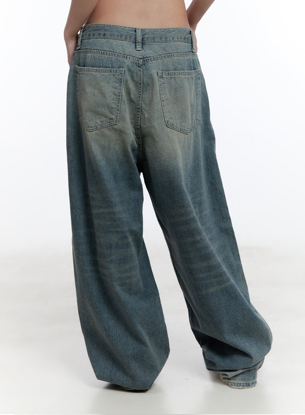 Jenna Relaxed-Fit Wide-Leg Jeans CU502 in blue, back view on model, dual patch pockets with topstitching, washed cotton denim with voluminous wide leg pooling at floor.