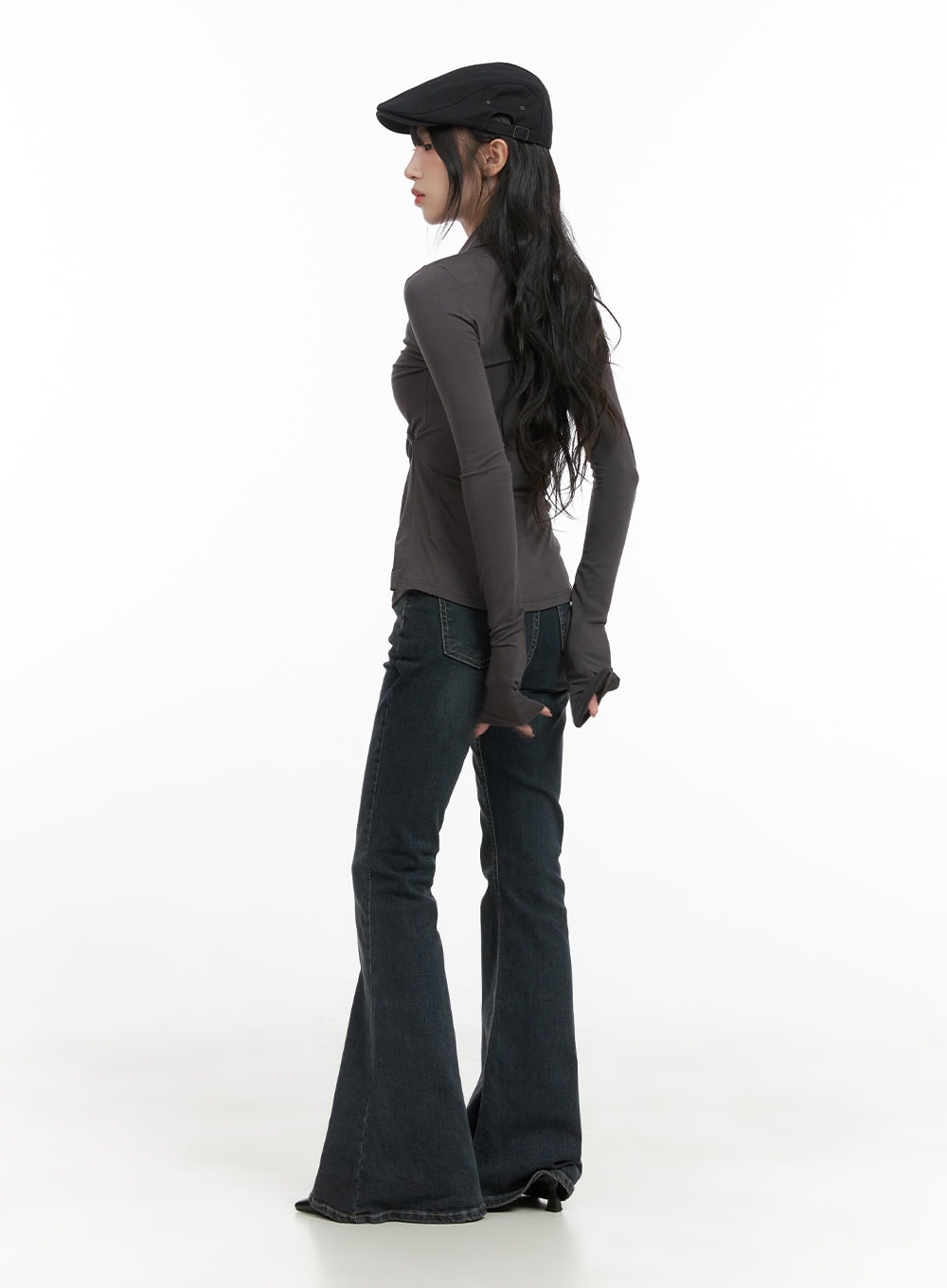Zadie Slim Washed Denim Bootcut Jeans CG421 in dark blue, back three-quarter view on model in black beret and grey top, showing elongated bootcut flare and rear seam line from waist to hem.