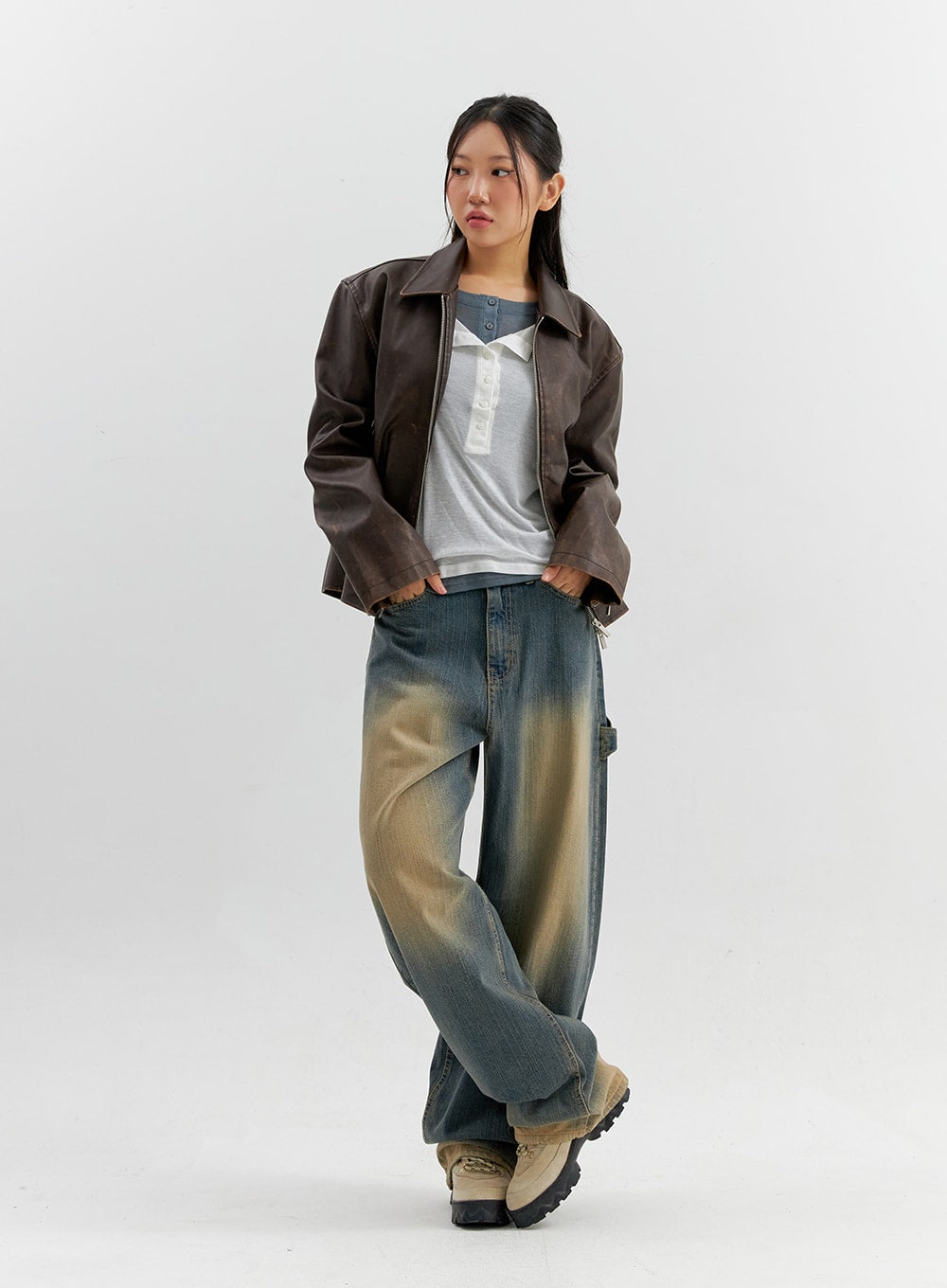 Vintage Wash Wide Leg Jeans CO306 in blue, full-body side-angle view on model, wide-leg vintage-wash denim pooling at hem, layered with leather jacket and henley tee.