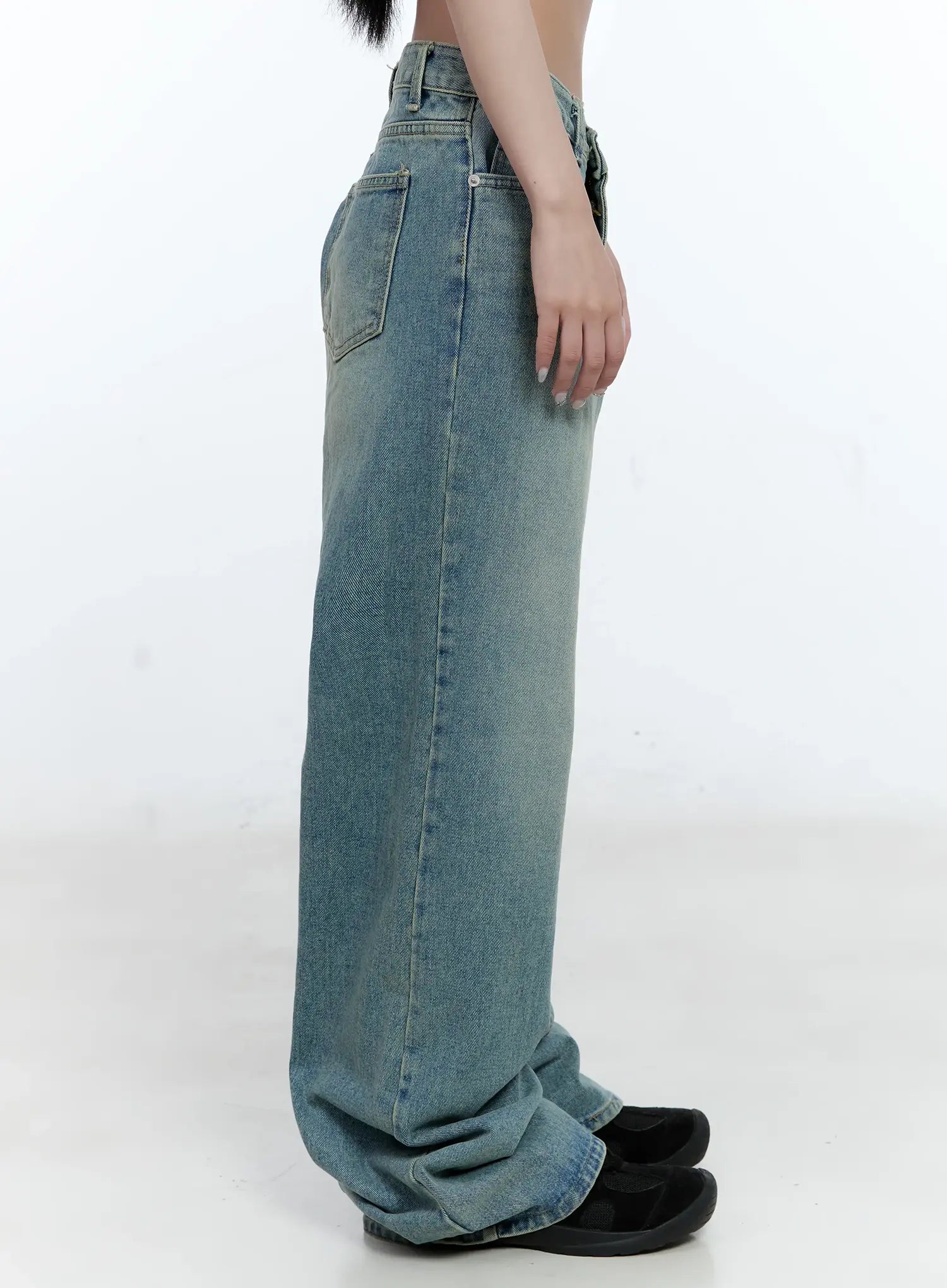 Haeun Wide-Leg Denim Jeans CG501 in blue, side view on model without top, full-length washed denim with exaggerated wide leg and floor-pooling hem, paired with black shoes.