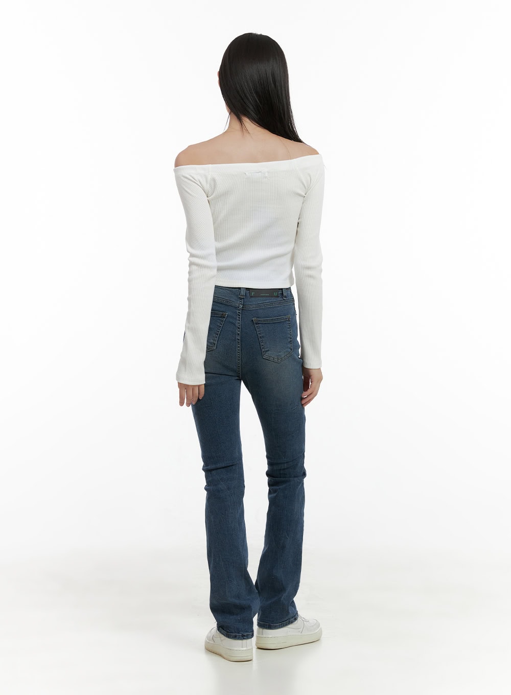 Pixie Slim Washed Bootcut Jeans CG427 in blue, back full-body view on model, revealing dual back pockets and bootcut hem flare, slim high-rise washed denim, styled with white off-shoulder top.