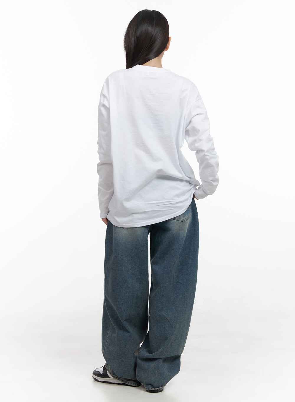 Mikaela Comfy Baggy Jeans CD411 in blue, back full-length view on model, washed cotton denim with back patch pockets, extra-wide leg pooling at floor, paired with white long-sleeve top.