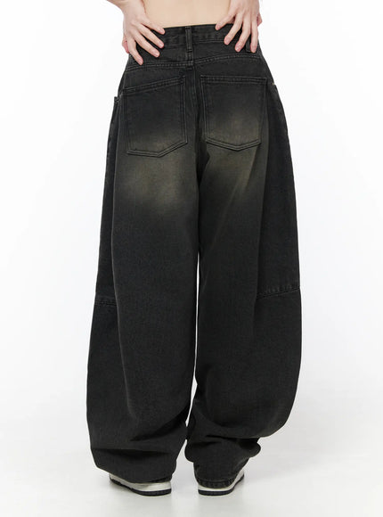 Bodie Vintage Wash Wide Leg Jeans CU519 in black, back view on model, two patch back pockets with stitched chevron detail, vintage fade wash, balloon wide leg hem pooling at sneakers.