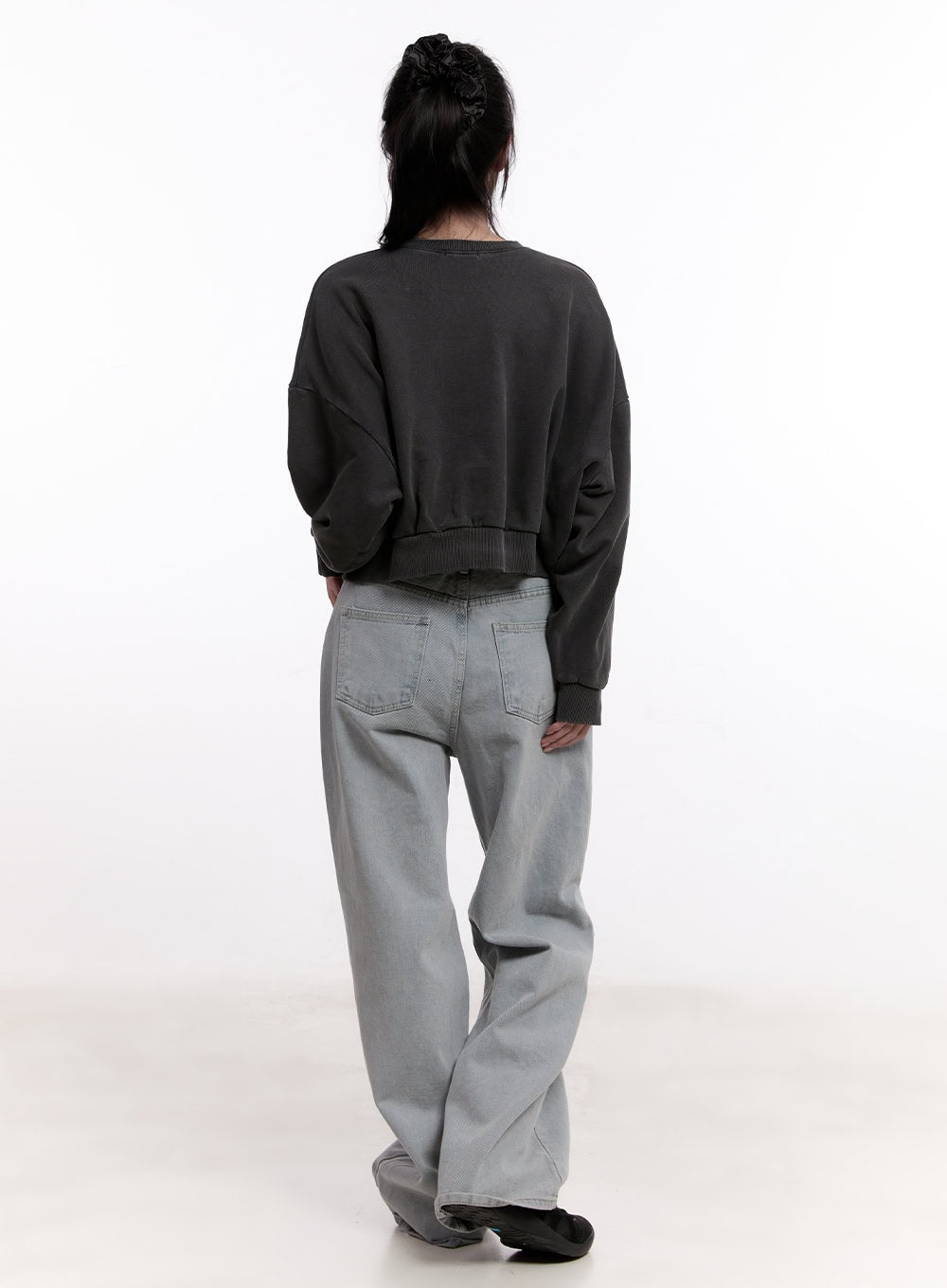 Casey Washed Baggy Wide-Leg Jeans CM526 in light gray, full back shot on model, washed baggy wide-leg denim showing back pockets and relaxed silhouette, paired with charcoal crop sweatshirt.