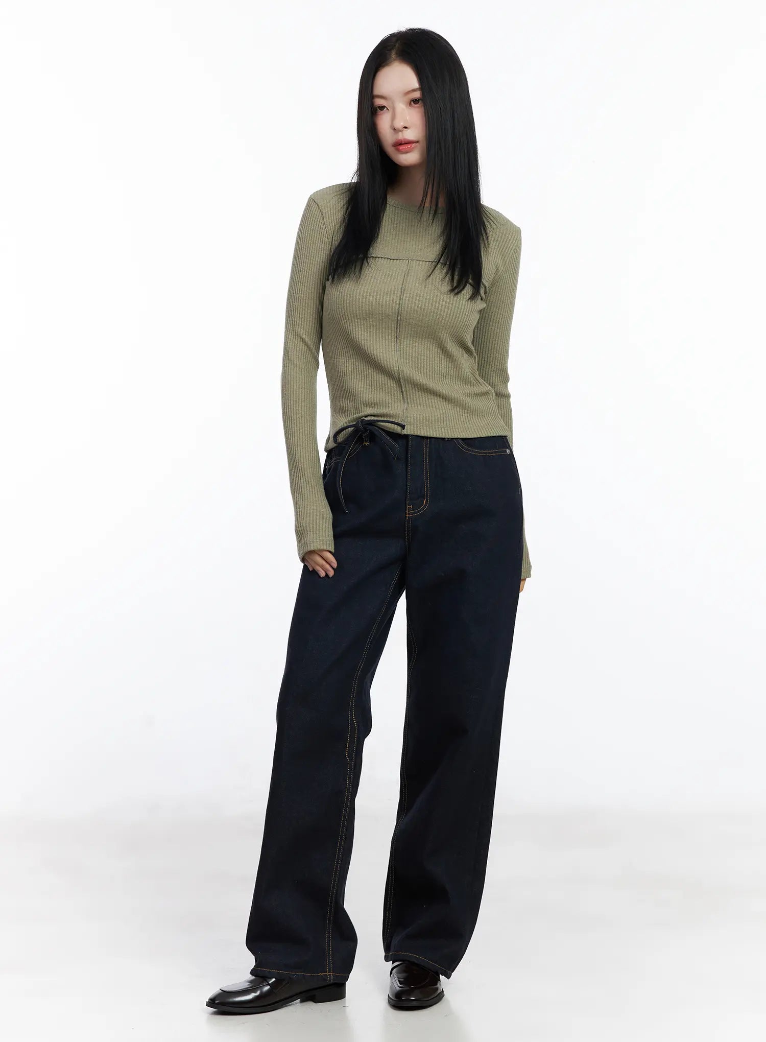 Mingi Non-Fade Semi-Wide Belted Jeans CJ519 in dark blue, full-length front styling shot on model, belted waist, paired with sage ribbed long-sleeve top and black loafers.