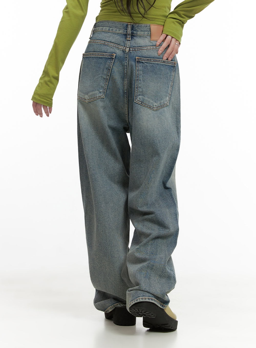 Millie Washed Baggy Jeans CG421 in Blue, back close-up on model, washed cotton denim showing two back patch pockets with tonal stitching, faded wash texture, and stacked hem.