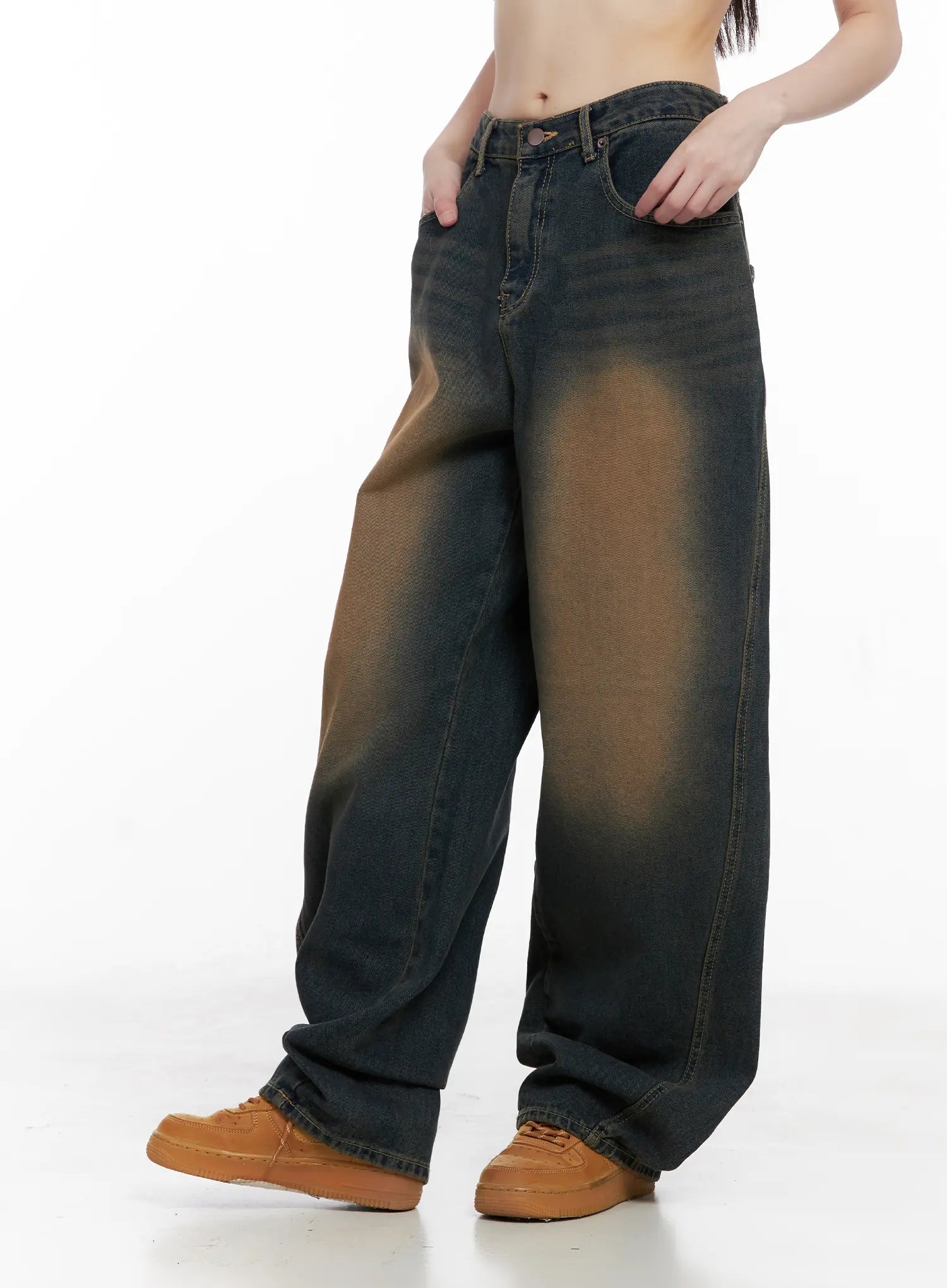 Jaycee Vintage Wash Baggy Jeans CG519 in dark blue, side view on model with hands in pockets, showcasing wide-fit silhouette and brown vintage wash fading on cotton denim.