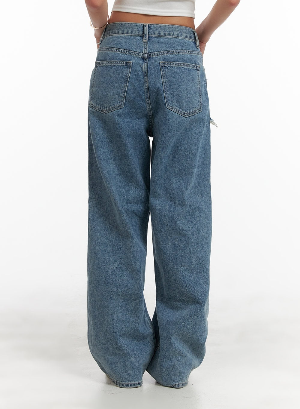 Layered Wide Leg Jeans CA430 in Blue, back close-up on model, washed cotton denim with dual back pockets, wide leg silhouette, clean back panel contrasting front destroyed layered detail.