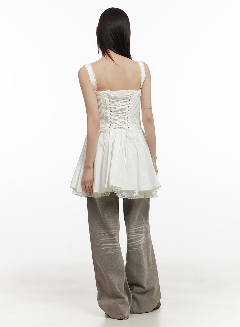 Hollie Vintage Wide-Leg Jeans CD426 in gray, back view on model, washed cotton denim with back patch pockets and whiskering detail, paired with white lace peplum cami top.