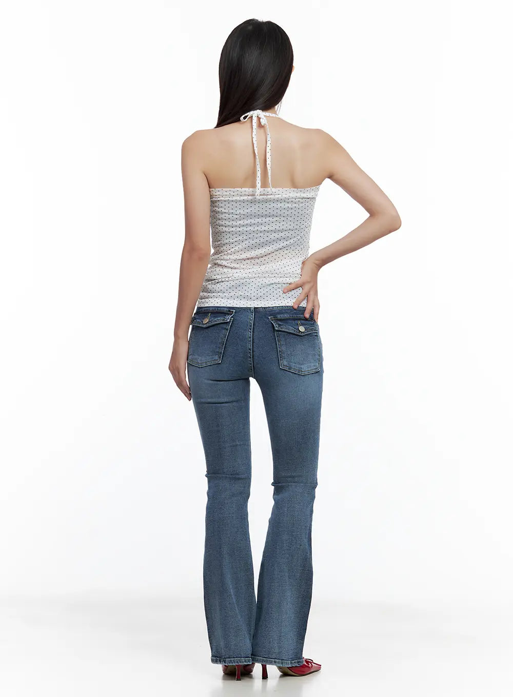 Beni Washed Flared Denim Jeans CL508 in dark blue, back full-length view on model, flap back pockets with button detail, washed denim, paired with halter top and red heels.