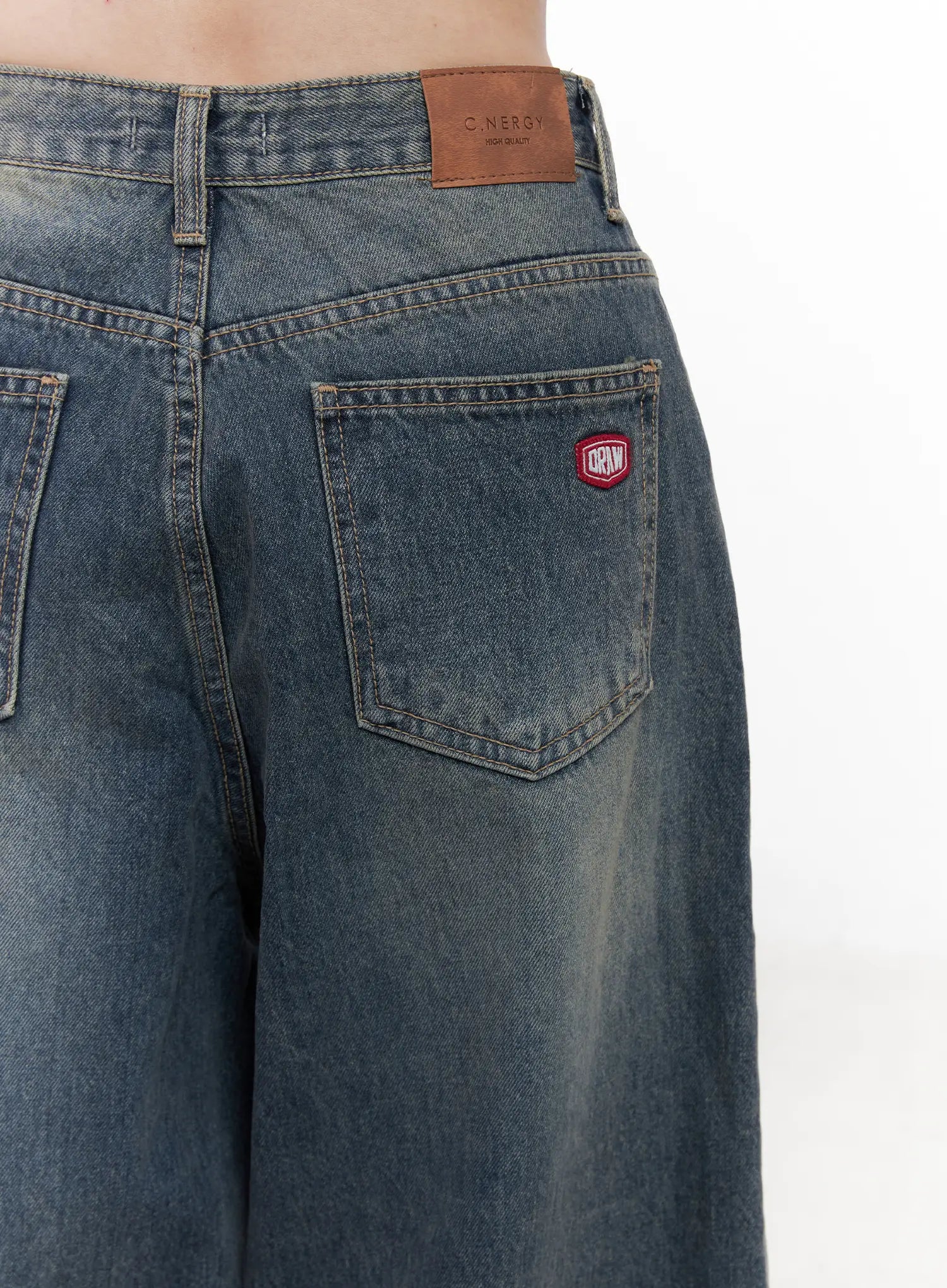 Tutt Washed Wide Leg Jeans CN504 in vintage blue, macro close-up of back pocket area, showing red logo patch, leather waistband label, contrast stitching and washed cotton texture.
