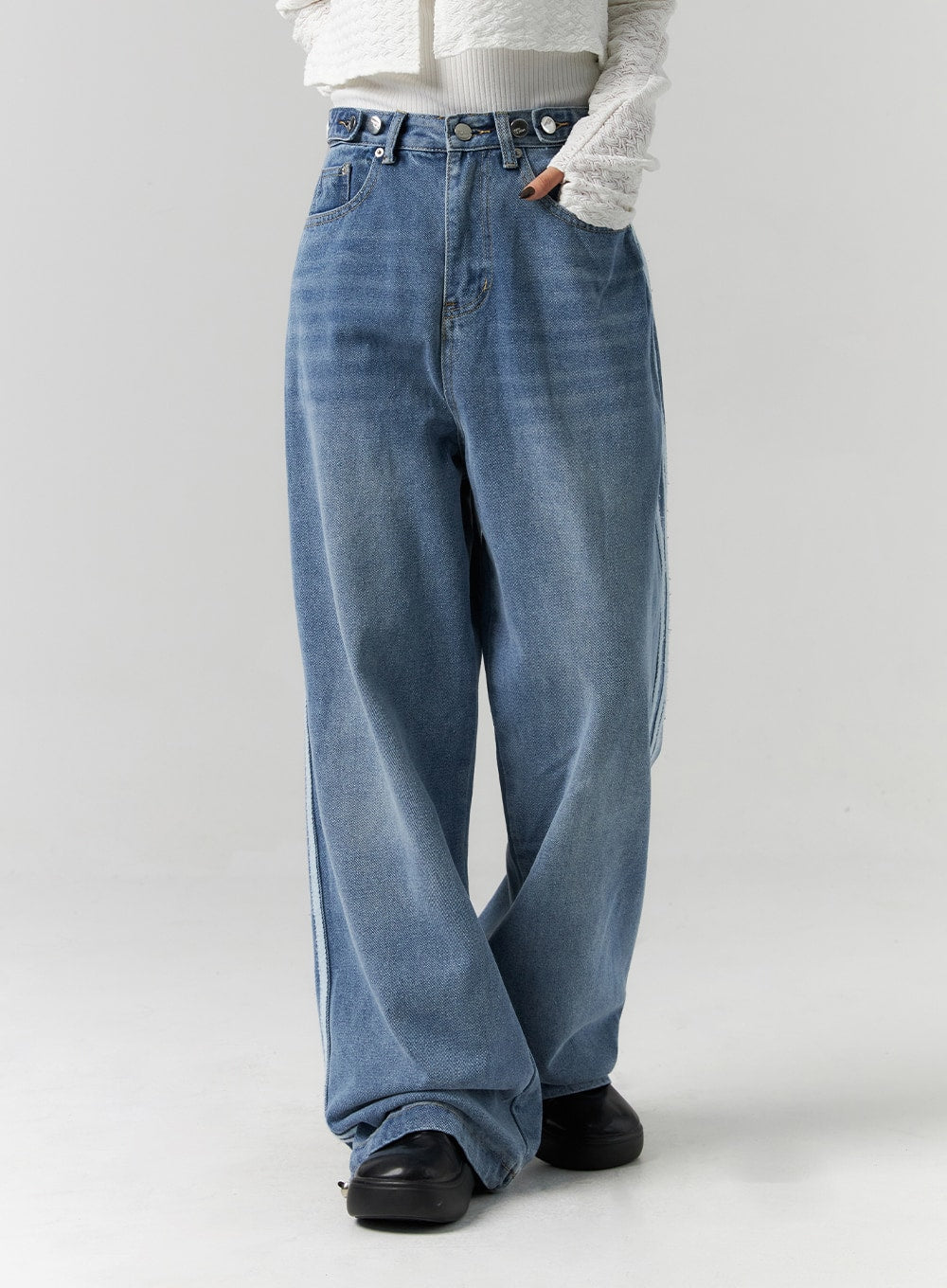 Side Stripes Wide Leg Jeans CS314 in blue, front thigh-to-hem close-up on model, washed cotton denim showing fading detail and multi-button waistband, extra-wide leg with side stripe hint.