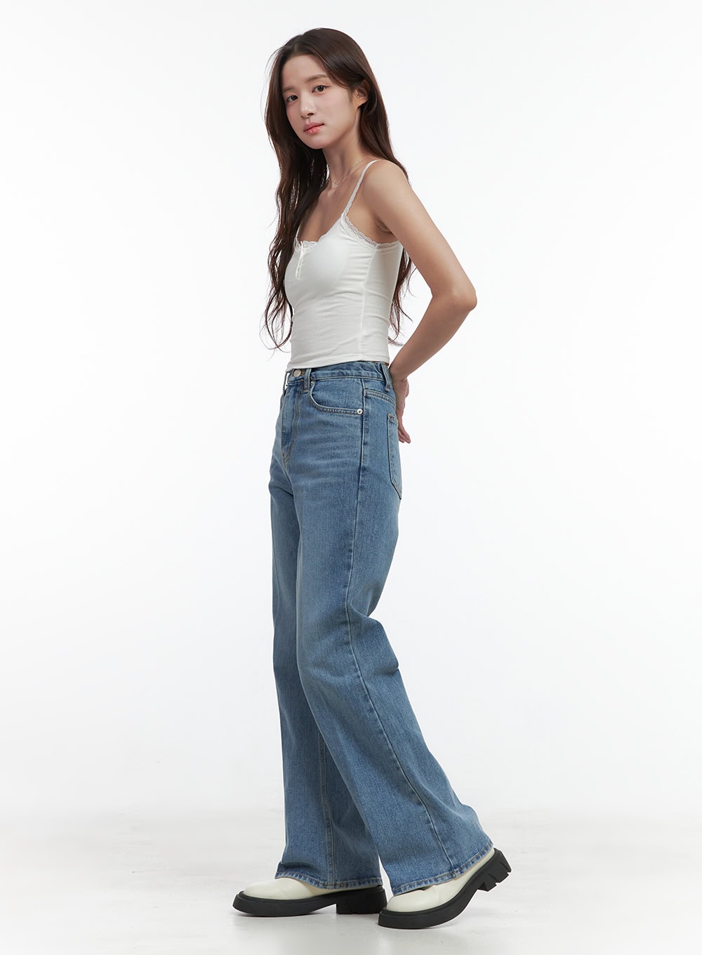 Aubrey Washed Classic Straight-Fit Jeans OO421 in blue, side view on model, high-waist wide straight-leg washed denim showing full leg length, paired with white lace cami and white platform shoes.