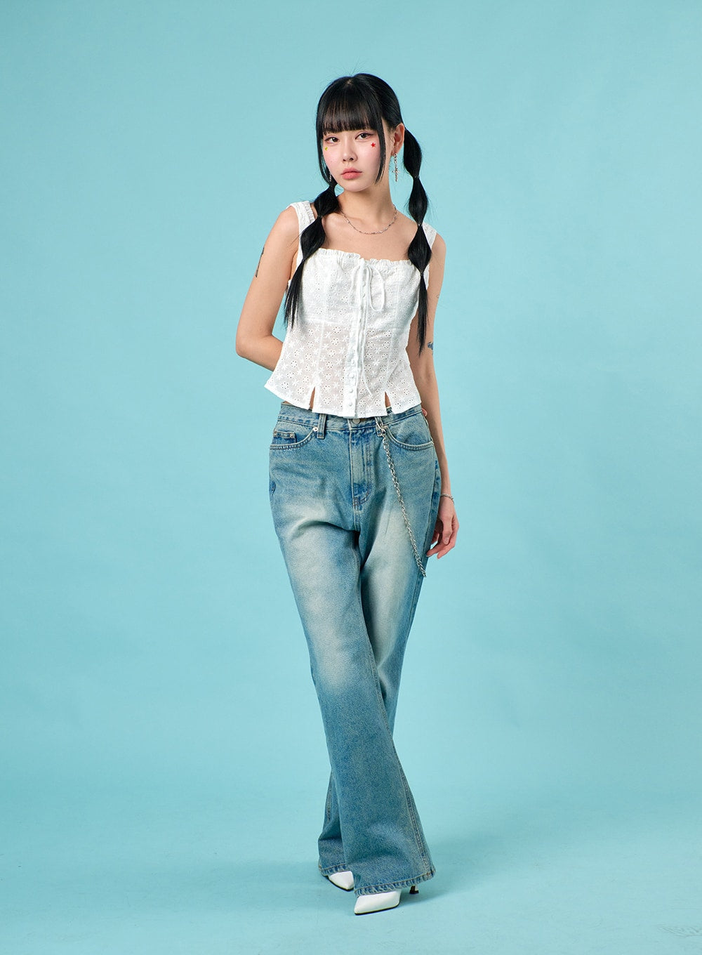 Washed Straight Leg Bootcuts Jeans IJ430 in light blue, three-quarter front view on model walking, bootcut hem and washed denim texture visible, styled with white eyelet corset and white mules.