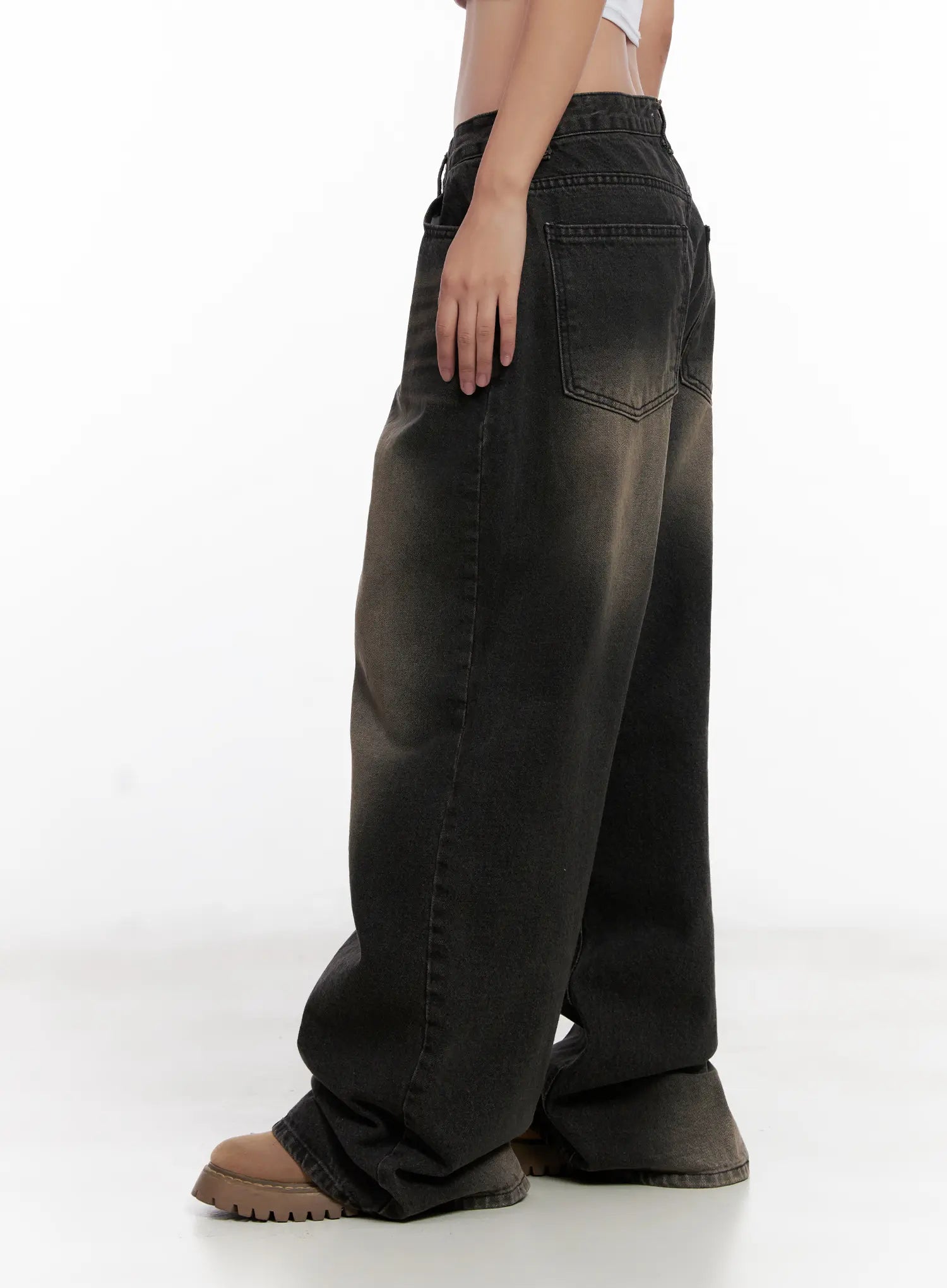 Ari Washed Wide-Leg Denim Jeans CL521 in Black, side close-up on model, highlighting back patch pocket, washed gradient fade from waist to hem, wide cotton leg pooling at floor.
