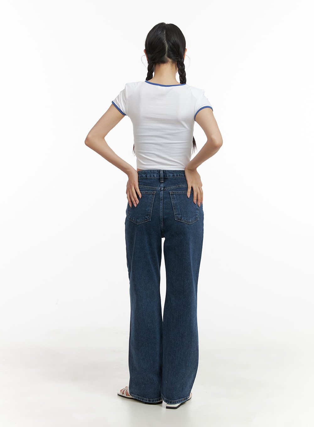 Recycled Straight Fit Jeans OM428 in dark blue, back full-body shot on model, showing rear patch pockets, center seam, and straight-leg hem length with white crop top.