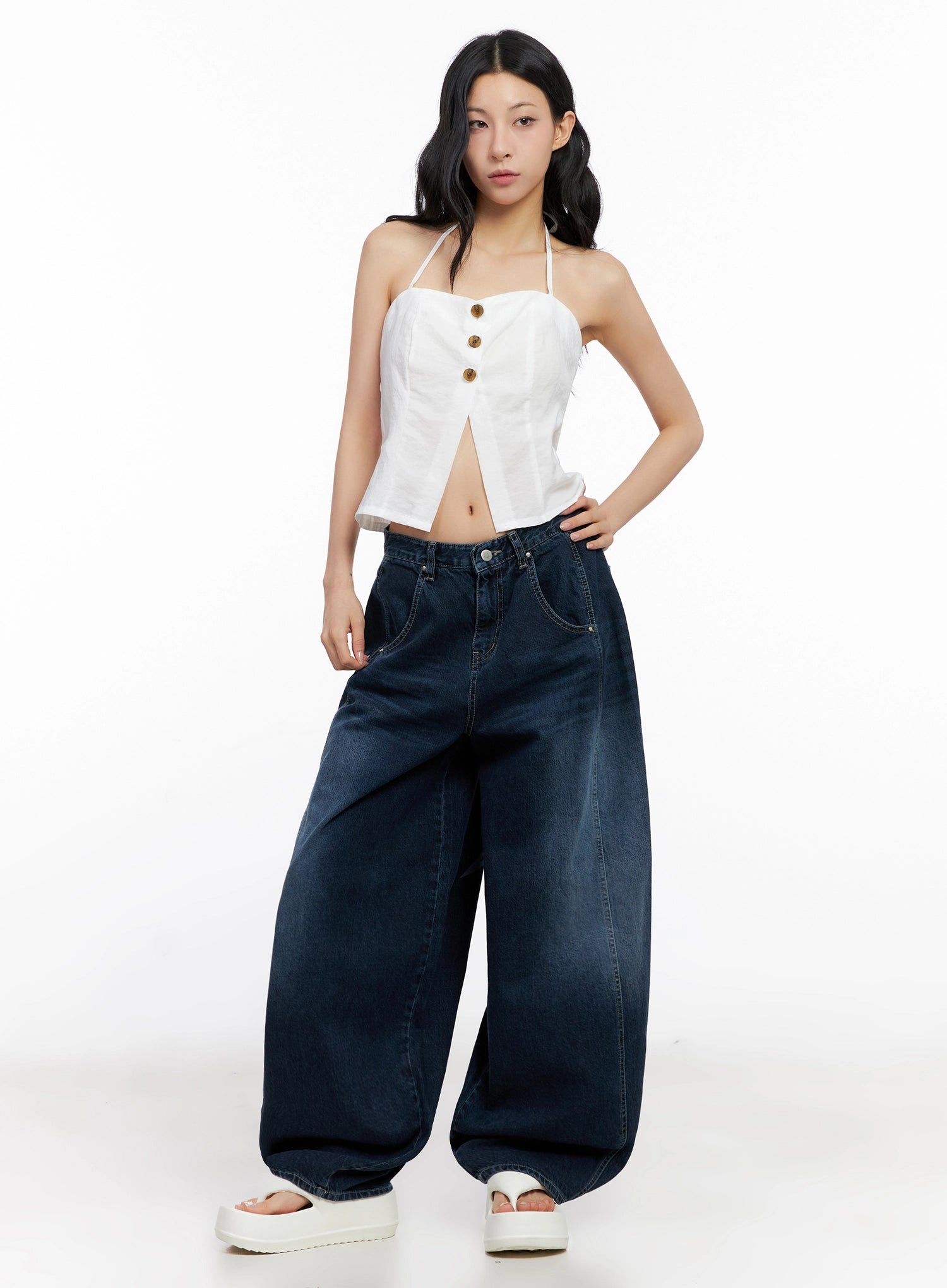 Sohee Angel Wing Print Wide-Leg Jeans IG508 in dark blue, full front view on model with hand on hip, exaggerated wide-leg silhouette and washed denim, styled with white halter crop top.