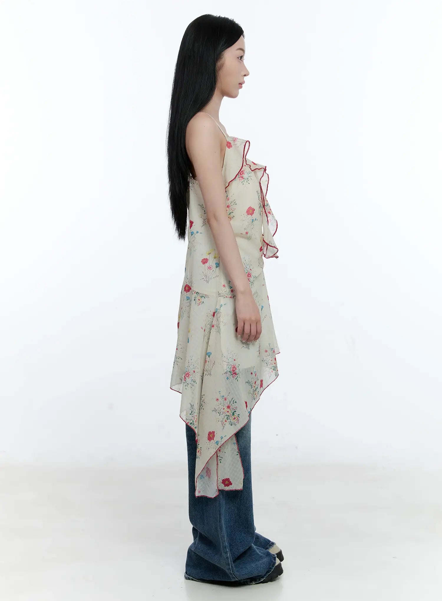 Gabi Distressed Semi-Flared Denim Jeans CG501 in dark blue, side outfit shot, paired with floral spaghetti-strap top, wide leg silhouette and semi-flared hem shown in full length.