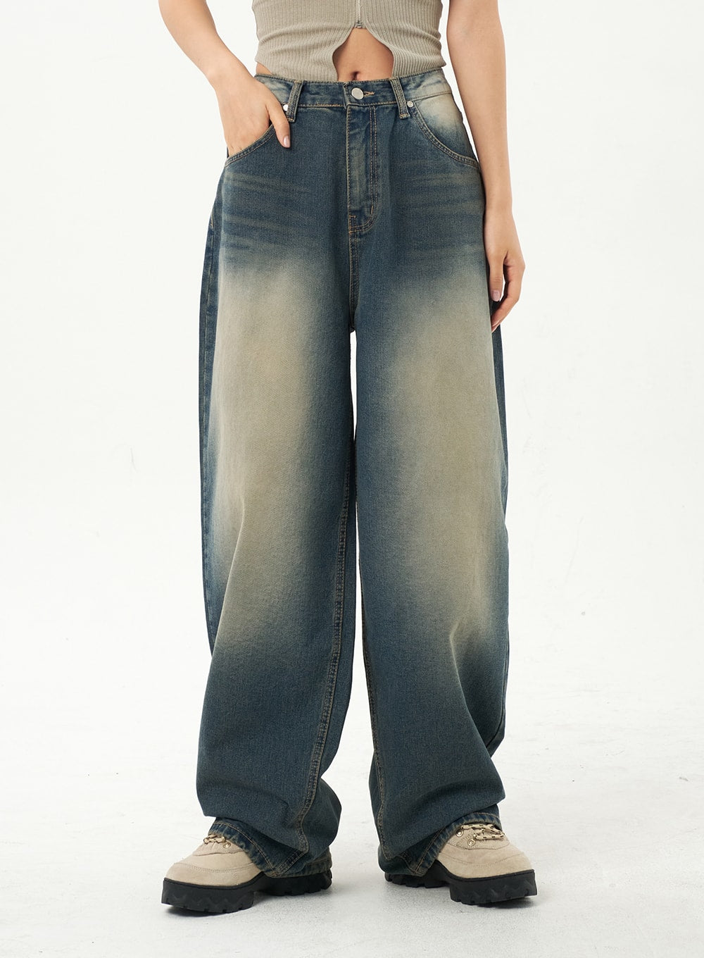 Mid-Rise Baggy Jeans CA325 in vintage blue denim, front waist-to-floor close-up on model, one hand in pocket, heavily faded yellow-to-blue gradient wash highlighting wide baggy leg shape.