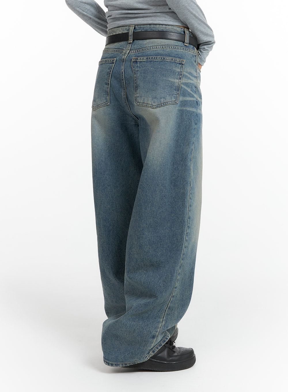 Washed Denim Wide-Leg Jeans CF419 in mid blue, back three-quarter view on model, showing rear pockets, washed denim finish, wide leg sweep, and black leather belt.