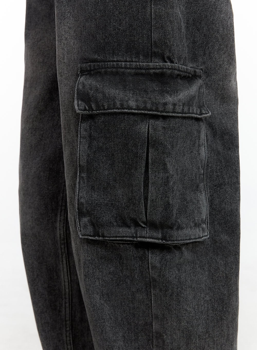 Neve Washed Cargo Denim Jeans IS427 in washed black, macro detail close-up of side cargo pocket, showing double-flap stitching and washed cotton denim texture.