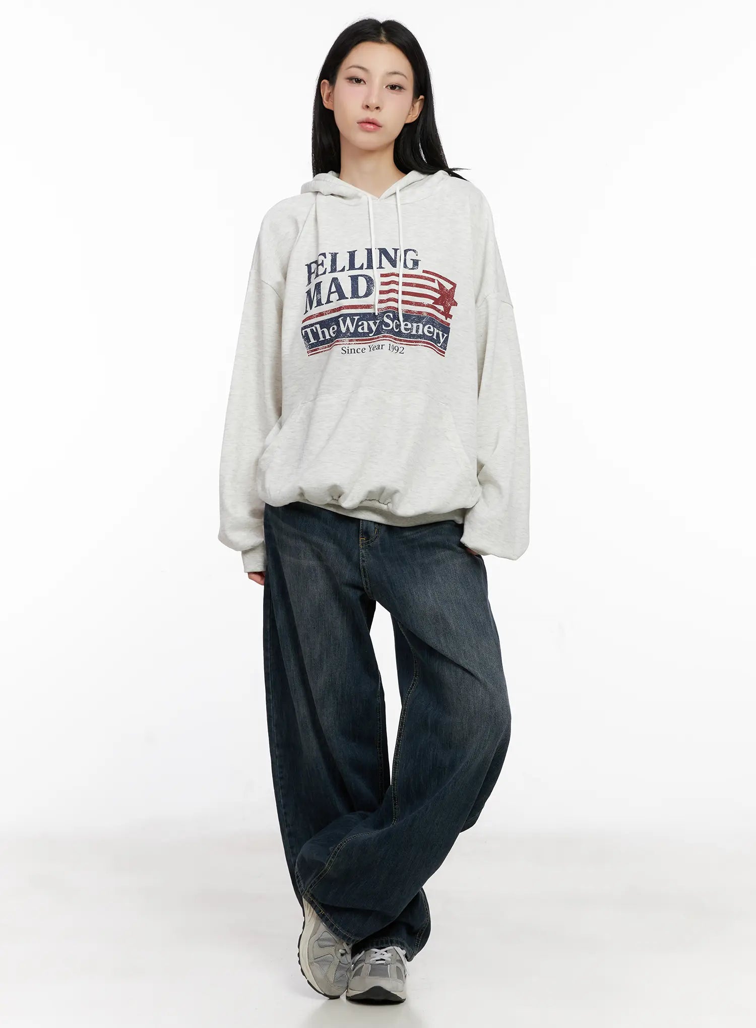 Seoy Washed Denim Jeans CG525 in dark blue, full-body front shot on model, paired with oversized grey graphic hoodie, long wide-leg silhouette with washed finish.