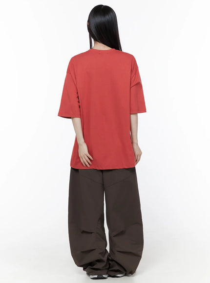 Wide Leg Pintuck Cargo Pants CU519 in dark brown, back full-length on model, wide balloon leg with pintuck seam lines, gathered hem pooling at floor, red tee on top.