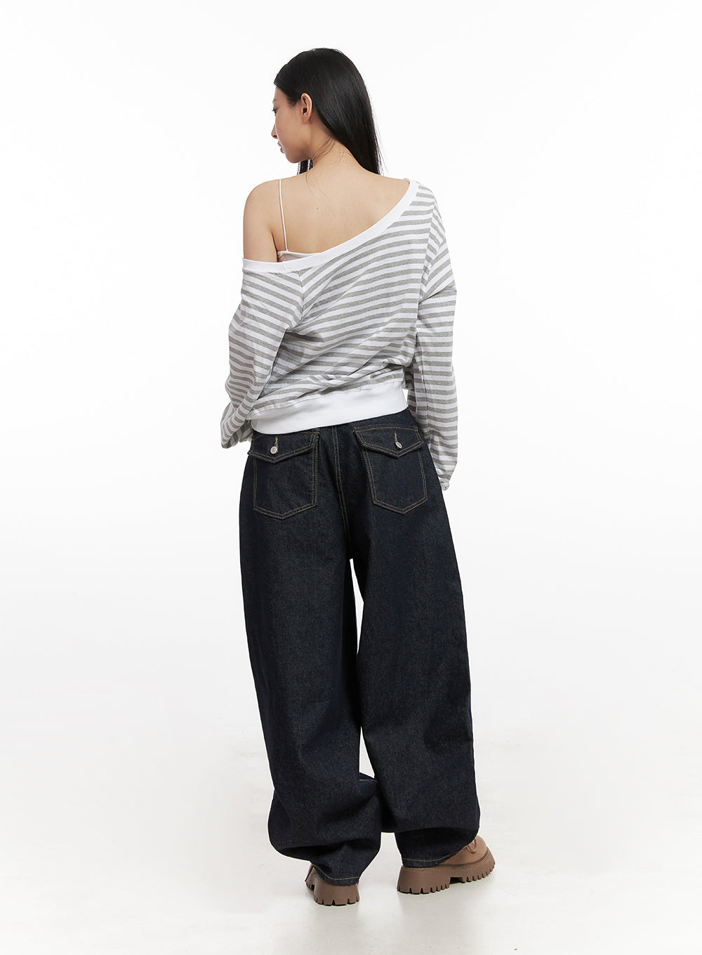 Lily Stitched Wide-Leg Jeans CN426 in dark blue, full back view on model, featuring two flap back pockets with button detail, structured wide-leg denim, paired with striped top and chunky boots.