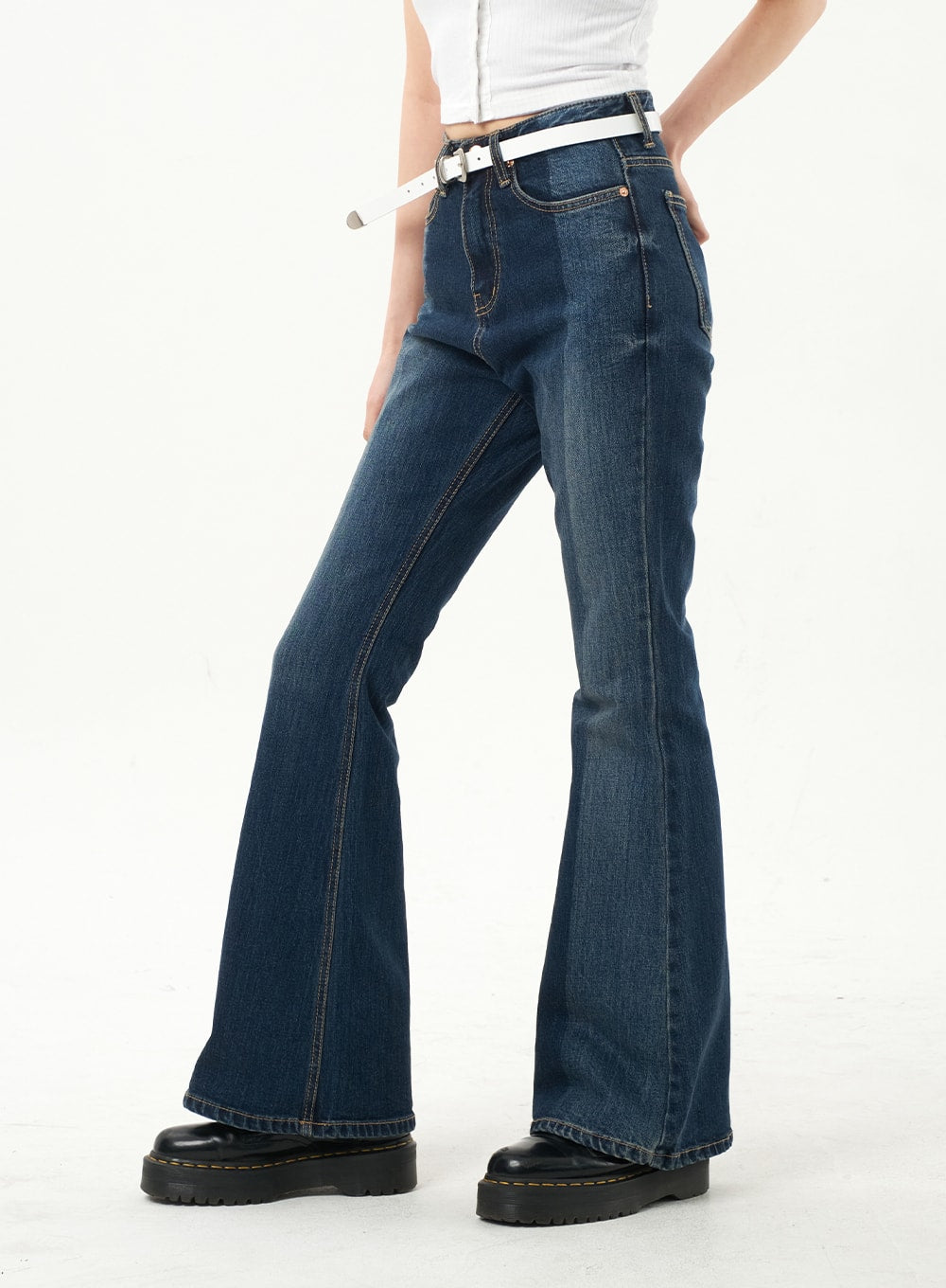 Dark Wash Bootcut Jeans CA328 in dark blue, side close-up on model, showing contrast topstitching, front seam detail, and dramatic bootcut flare from knee to hem.