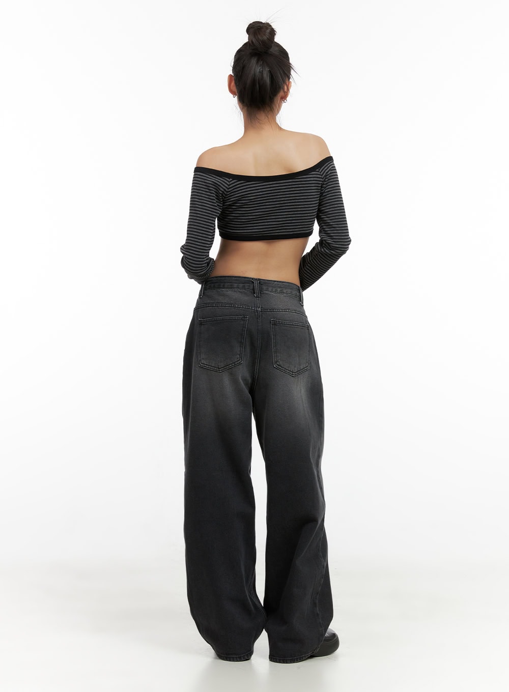 Delilah Pin-Tuck Washed Denim Baggy Jeans CO424 in black, full back view on model, back pockets and wide baggy leg with washed fade shown, paired with striped crop top.