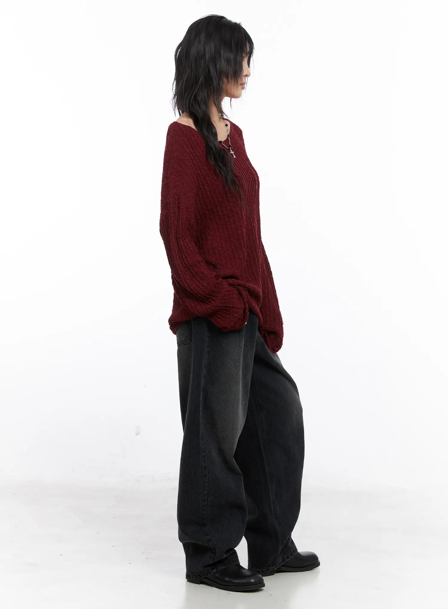 Ivey Washed Baggy Jeans CC1809 in black, side full-length editorial shot on model, oversized washed denim paired with burgundy chunky knit sweater, grunge street style.