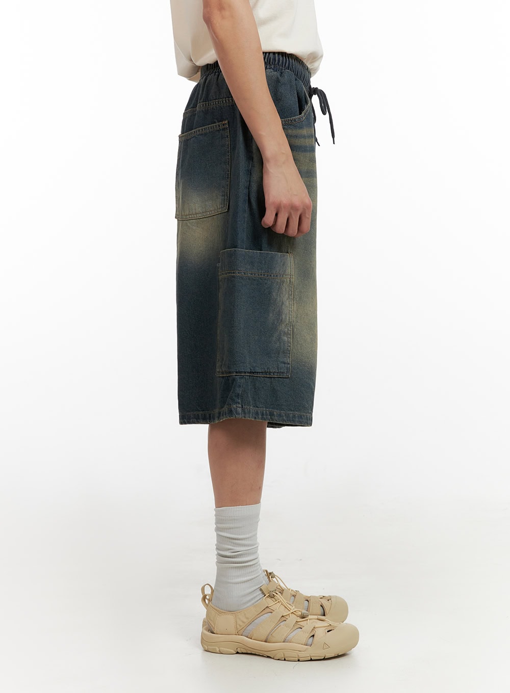 Men's Denim Washed Shorts (Blue) IL404 in blue, side view on model, showing elasticated drawstring waistband, below-knee length, and cargo pocket placement with faded wash.