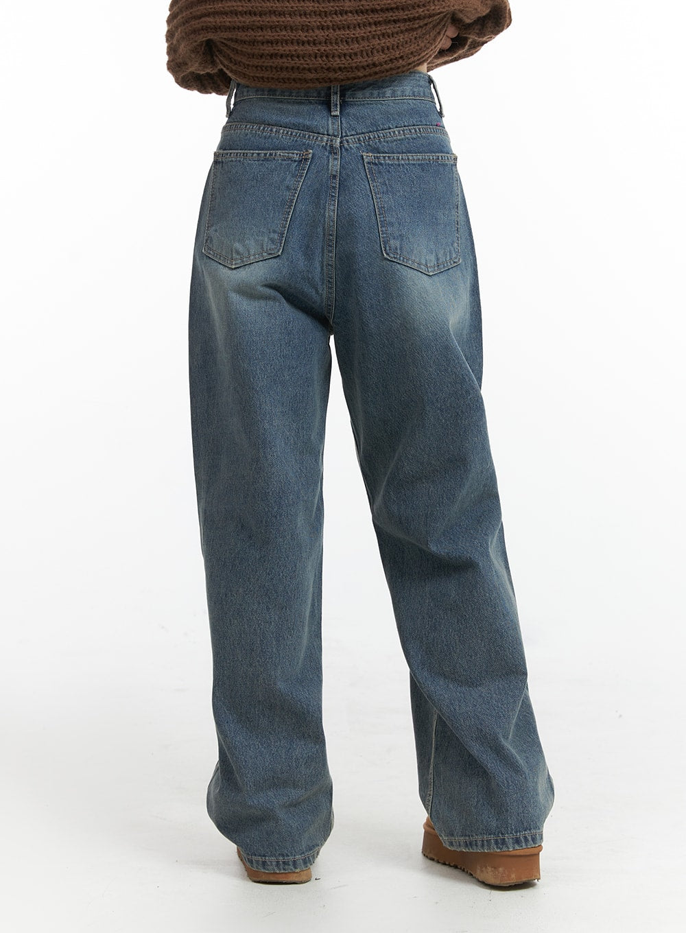 Solid Mid Waist Pocket Straight Leg Jeans IJ411 in washed blue, back full-length view on model, wide-leg denim with back patch pockets and washed finish, paired with brown knit cardigan and tan boots.