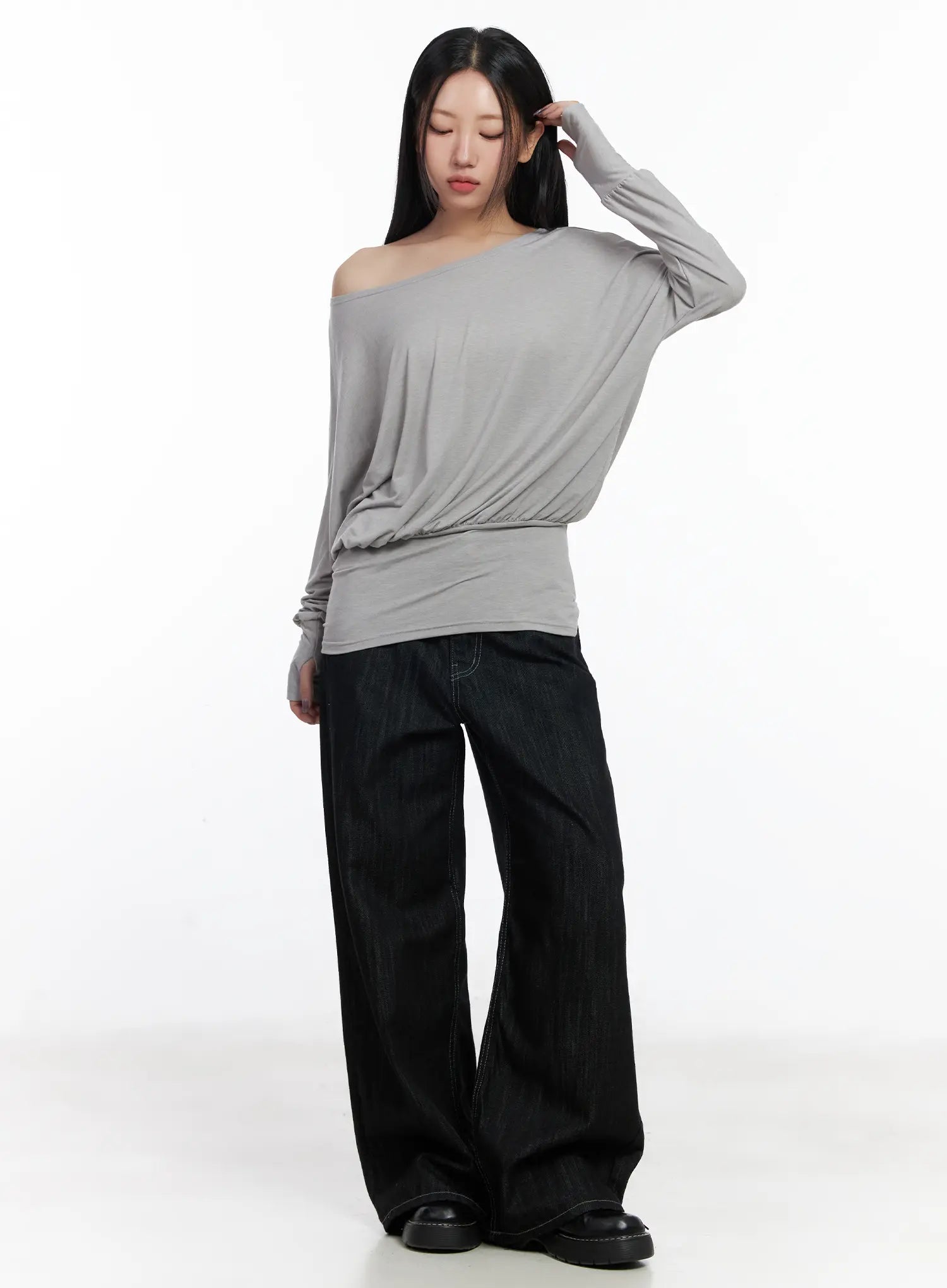 Violet Studded Baggy Jeans CJ530 in black, front full-body shot on model styled with grey draped off-shoulder top, relaxed wide-leg cotton denim, black loafers, casual street look.