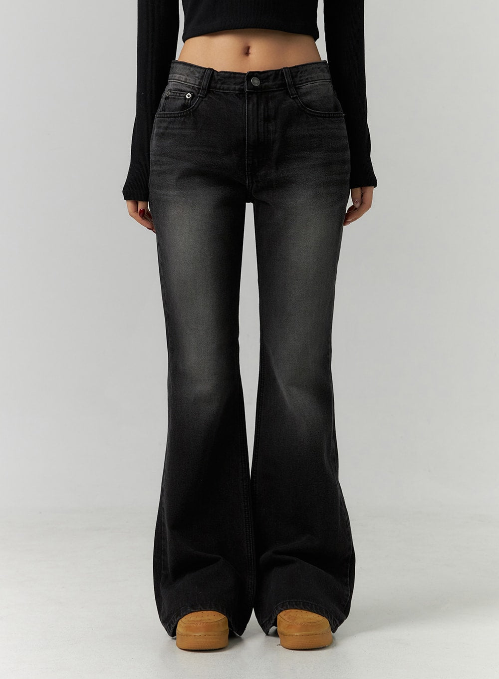 Low Rise Bootcut Jeans CD304 in black, front lower-body close-up on model, low-rise waistband with five-pocket styling, washed denim texture and wide bootcut flare clearly shown.