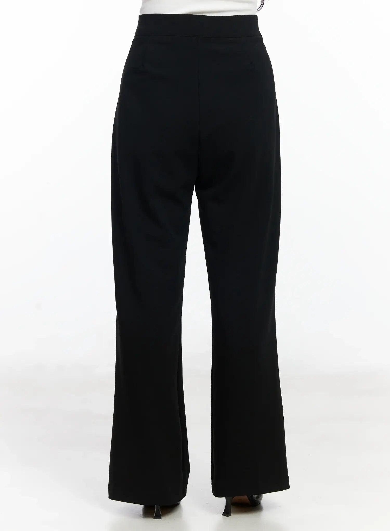 Hip Pad Slacks IJ529 in black, back view on model, smooth high-rise waistband, slim hip-to-thigh fit flaring to bootcut hem, long inseam length.