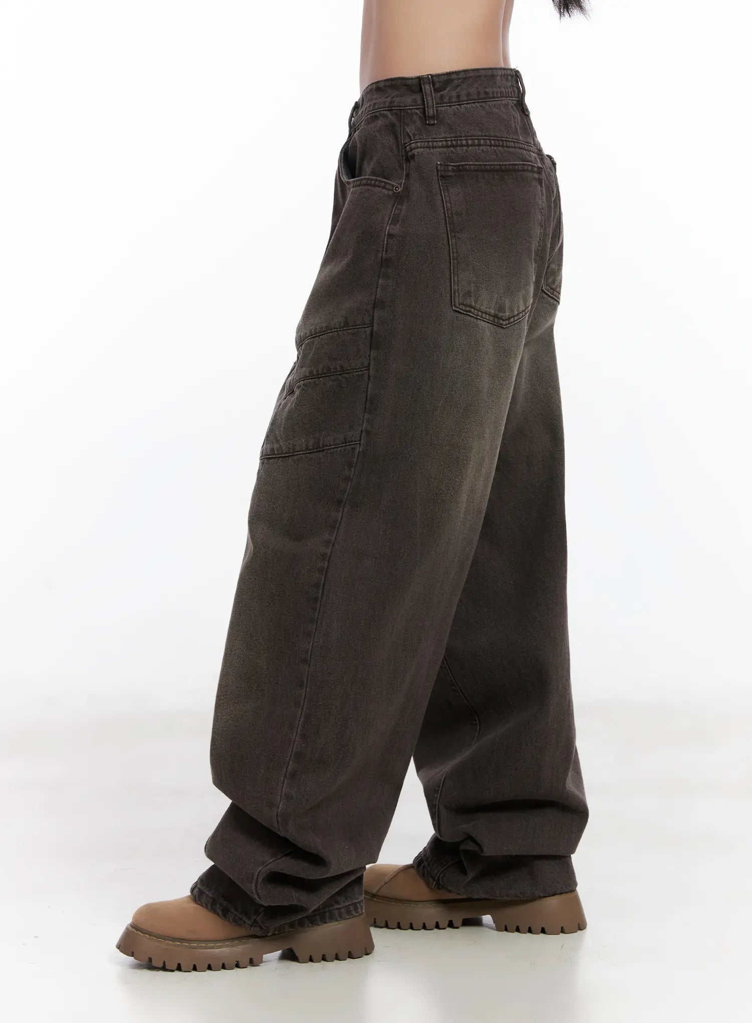 Elia Washed Baggy Jeans CN528 in dark brown, side close-up from waist to hem, highlighting wide-fit silhouette, curved panel seams, and rear pocket placement on washed denim.