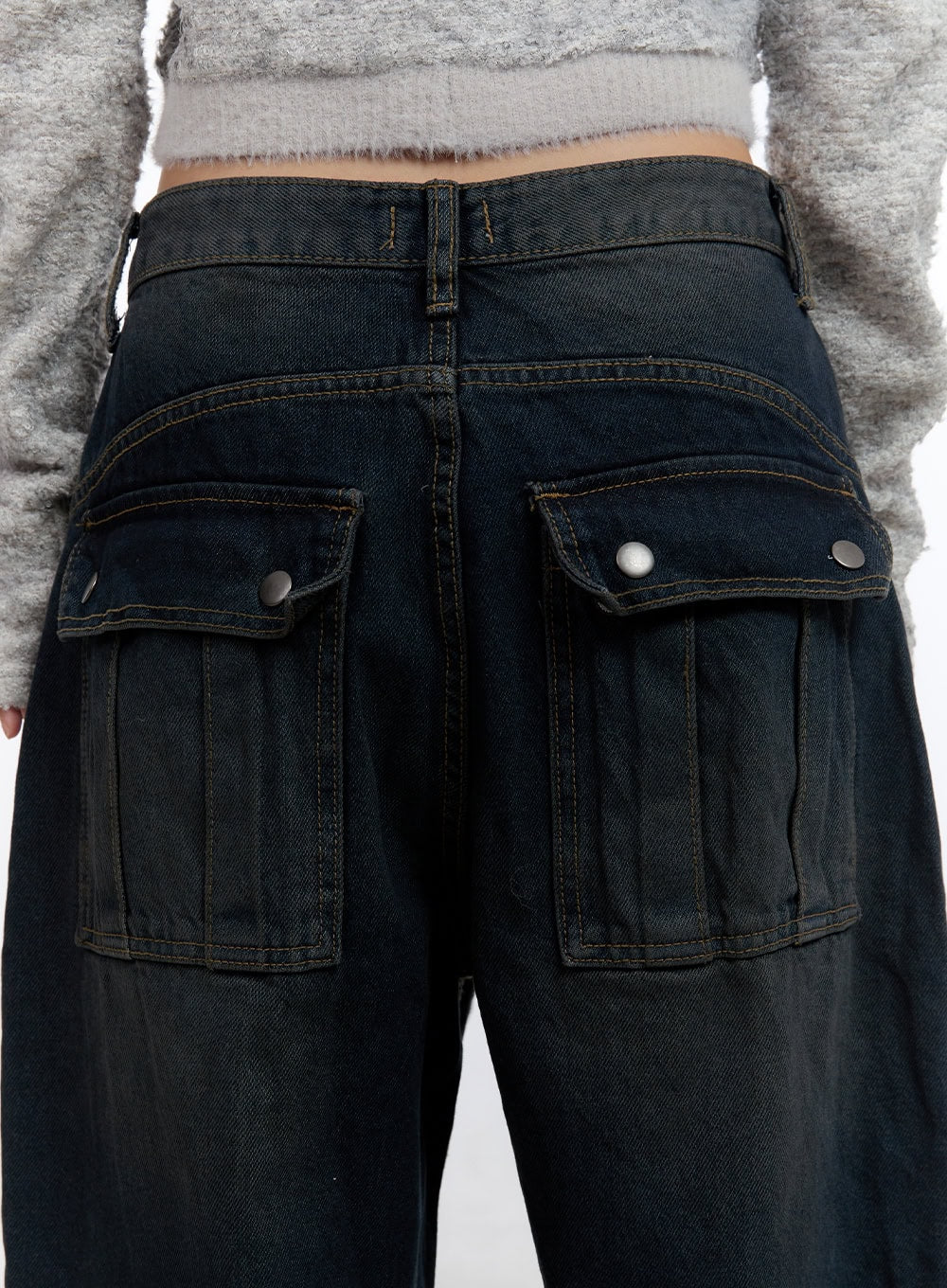 Lyla Wide Leg Jeans CO423 in dark blue, back close-up detail on model, dual snap-button cargo pockets with contrast topstitching on washed dark denim waistband.