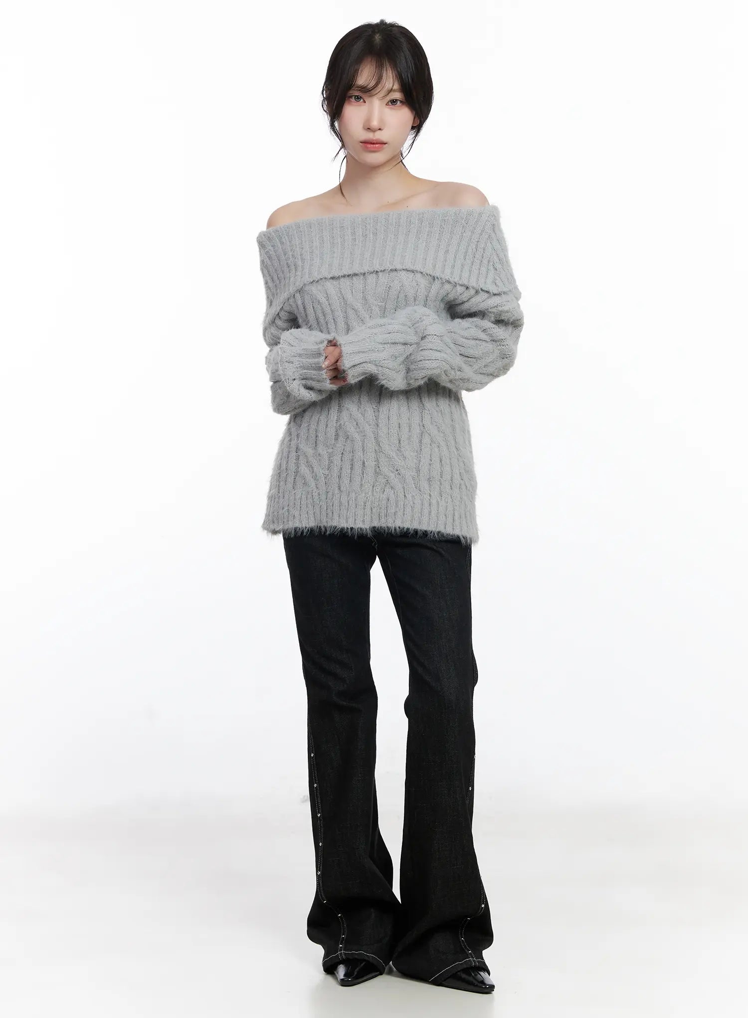 Dahy Stylish High-Waisted Bootcut Jeans CJ526 in black, full-length front shot on model paired with grey off-shoulder cable-knit sweater, silver stud side seam and bootcut silhouette clearly visible.