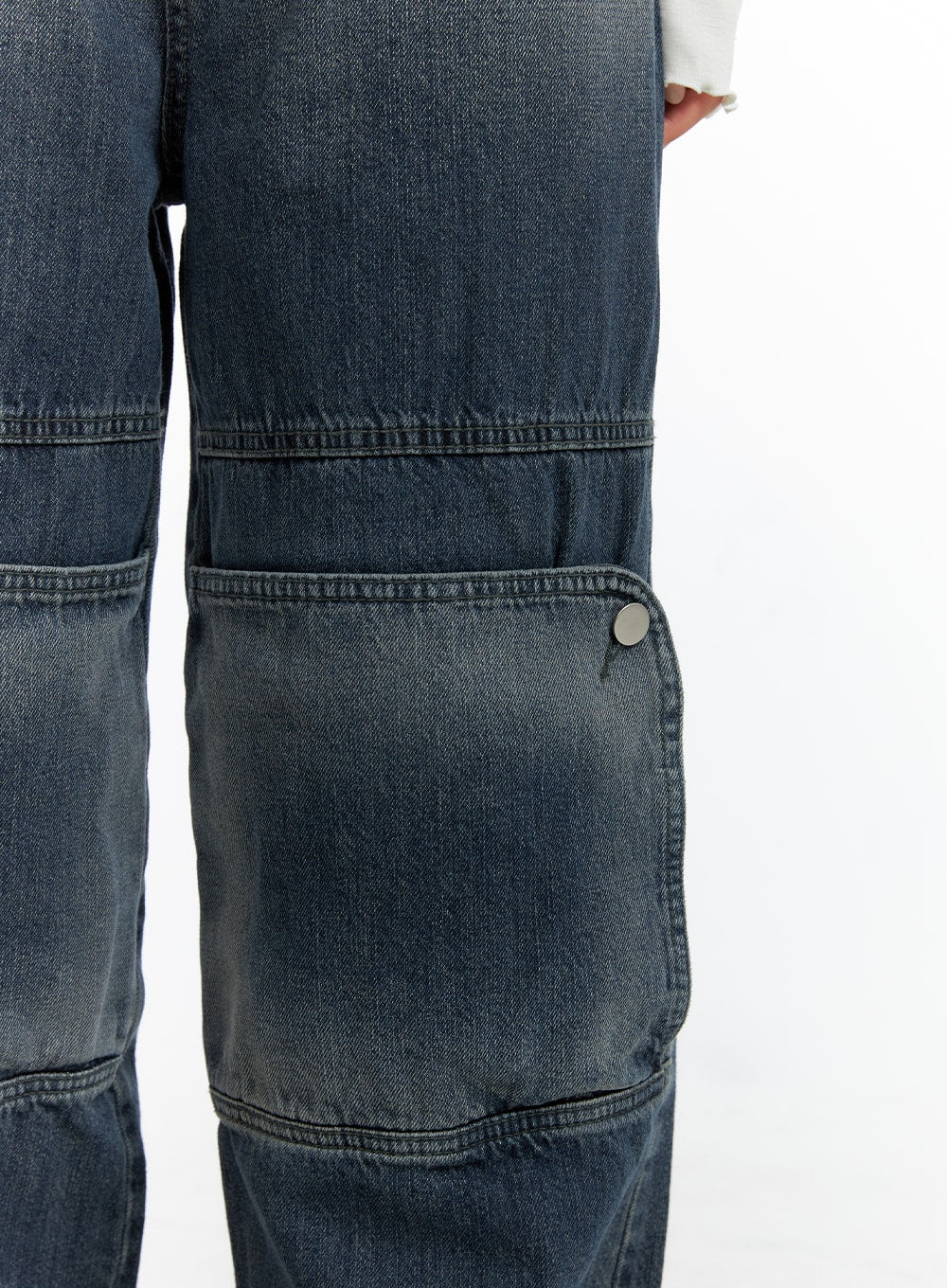 Denim Wide Leg Jeans CF408 in washed dark blue, macro close-up detail of paneled knee seam and silver snap-button side pocket on heavy cotton denim fabric.