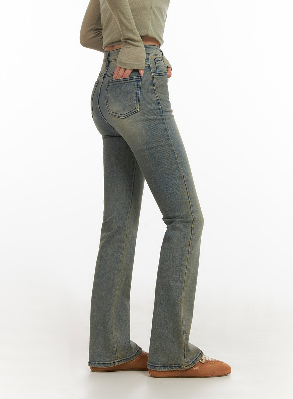Cathy Washed Slim-Fit Flared Jeans IJ503 in vintage blue, side view on model, slim thigh tapering into flared hem, back pocket and washed denim texture visible, styled with olive top.