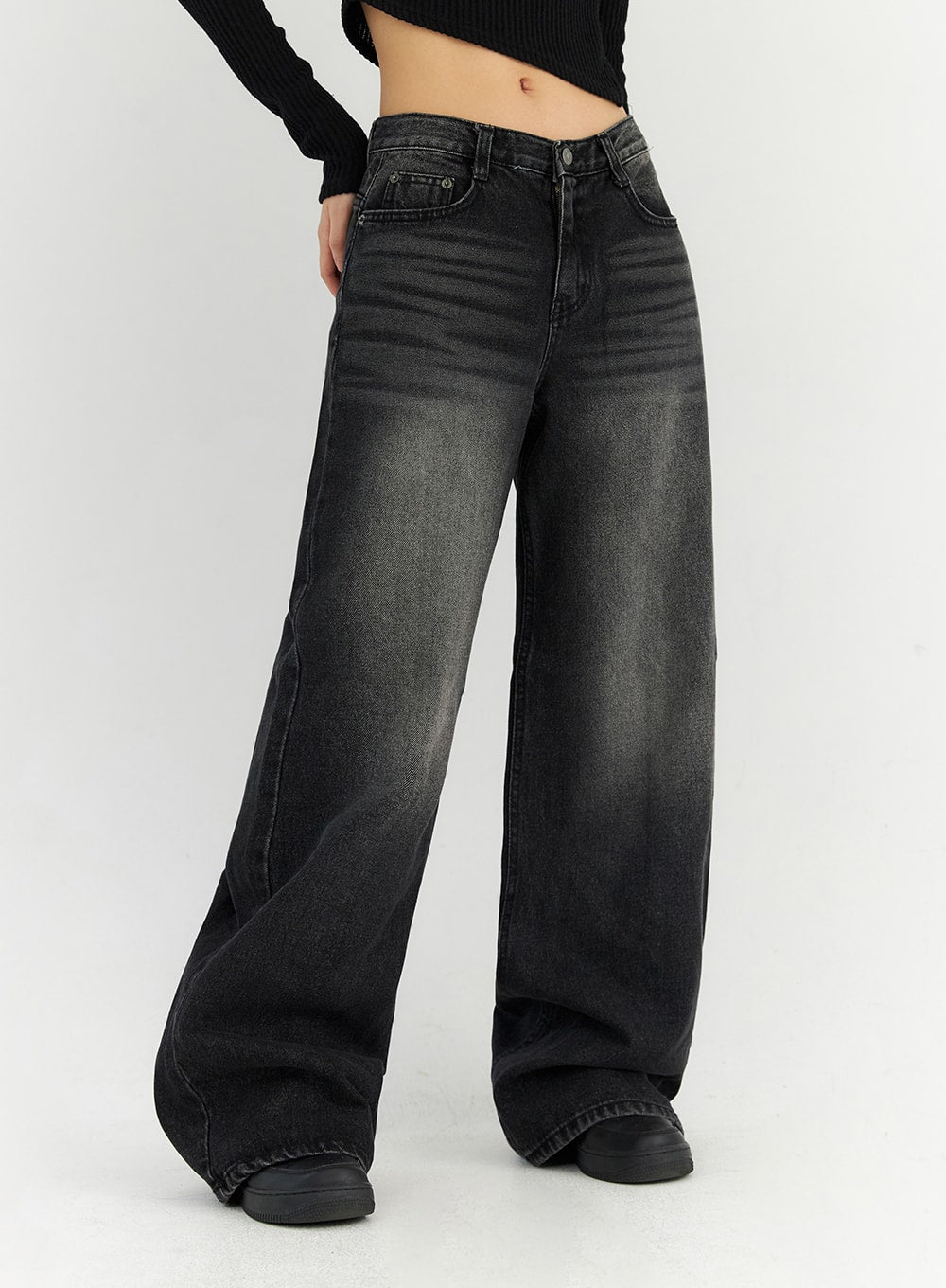 Back Slit Washed Wide Leg Jeans CN306 in Black, side close-up on model, low-waist washed denim, wide leg with subtle whiskering, floor-grazing tall length and clean seam detail.