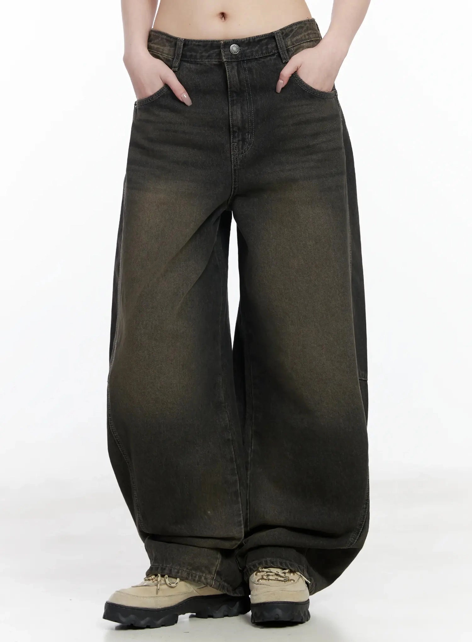 Tracey Vintage Black Washed Wide Leg Jeans IJ528 in black, front mid-shot on model hands in pockets, balloon wide leg with brown vintage wash gradient, long length pooling at chunky sneakers.