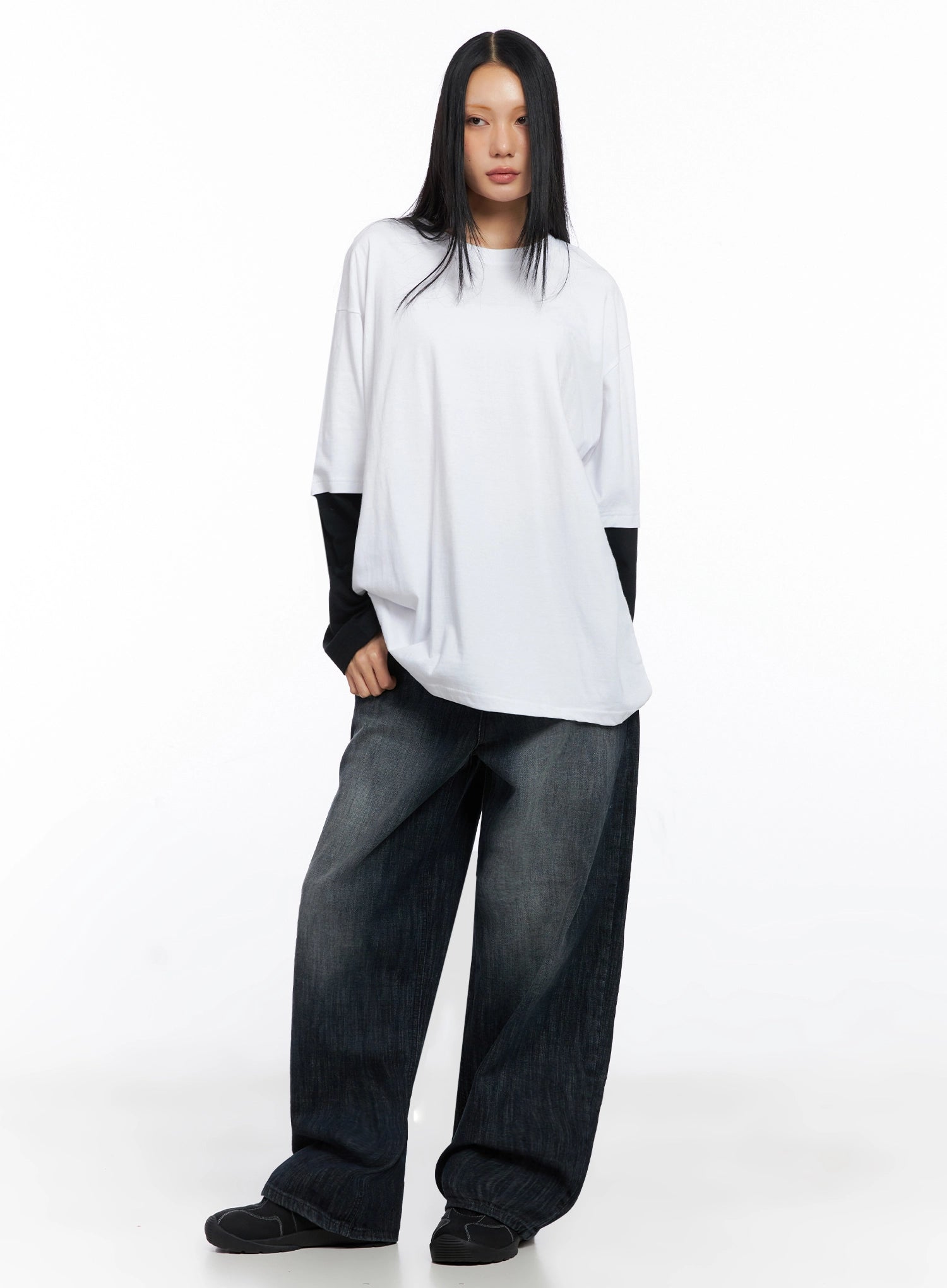 Minnell Vintage-Wash Wide-Leg Jeans IO517 in dark blue, full-body front shot, model in white oversized layered long-sleeve tee, showing floor-length wide leg and vintage-wash cotton denim.