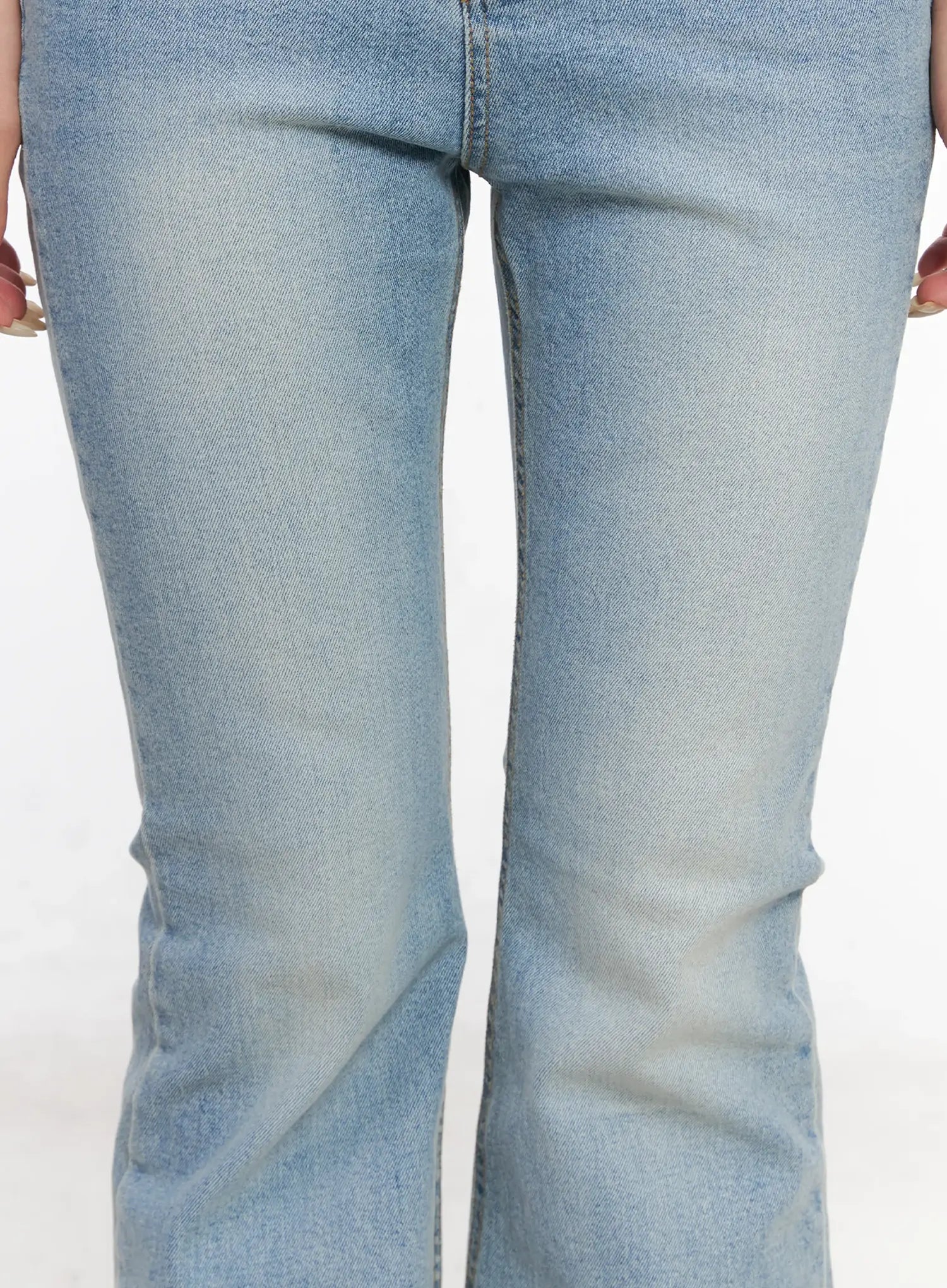 Byeol Washed Flare Denim Jeans CL525 in light blue, close-up of lower leg and flared hem on model, washed cotton denim with subtle fading and bootcut flare silhouette.
