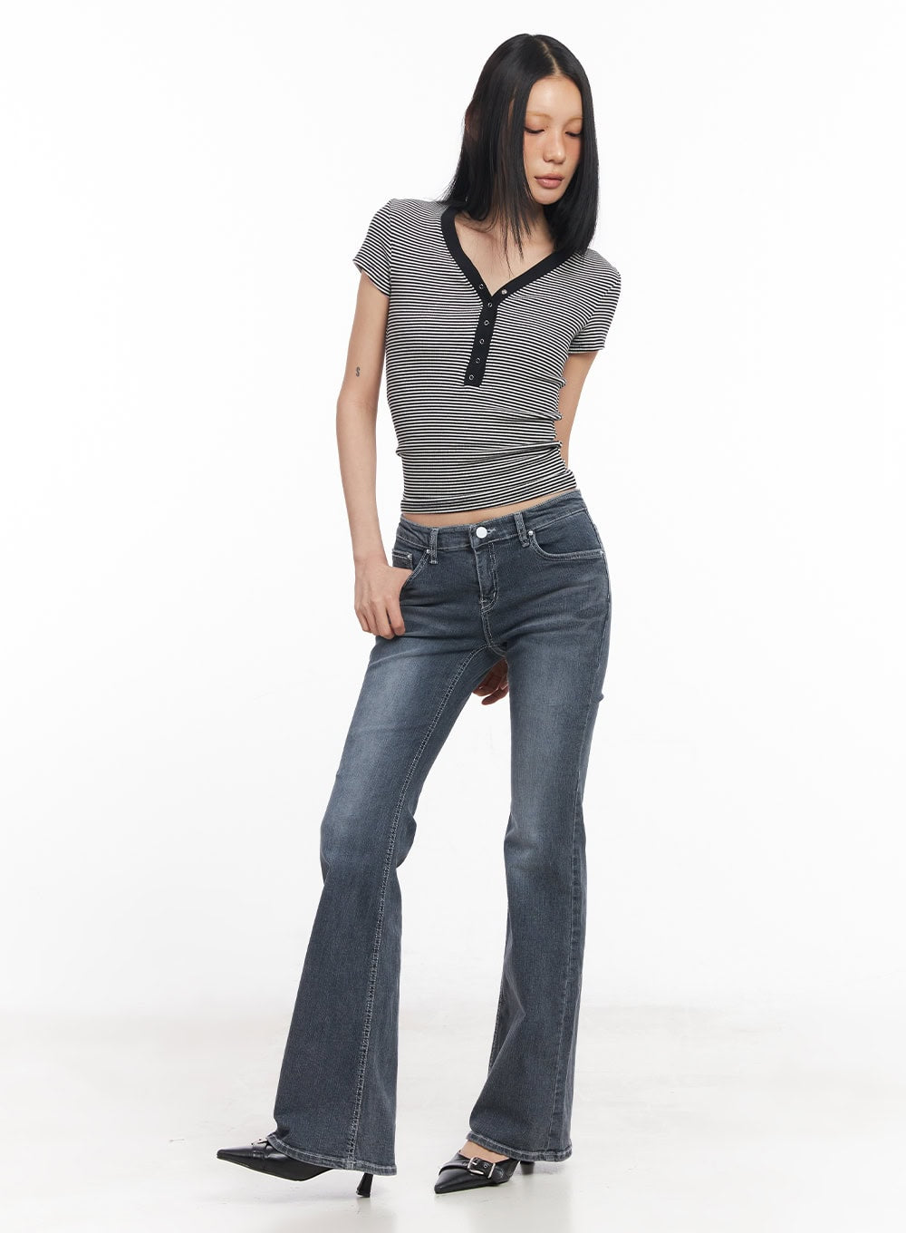 Nadeline Slim Bootcut Jeans CY528 in dark gray, full-body front shot on model with downward gaze, slim bootcut washed denim, slight flare from knee, paired with striped crop top and mule heels.