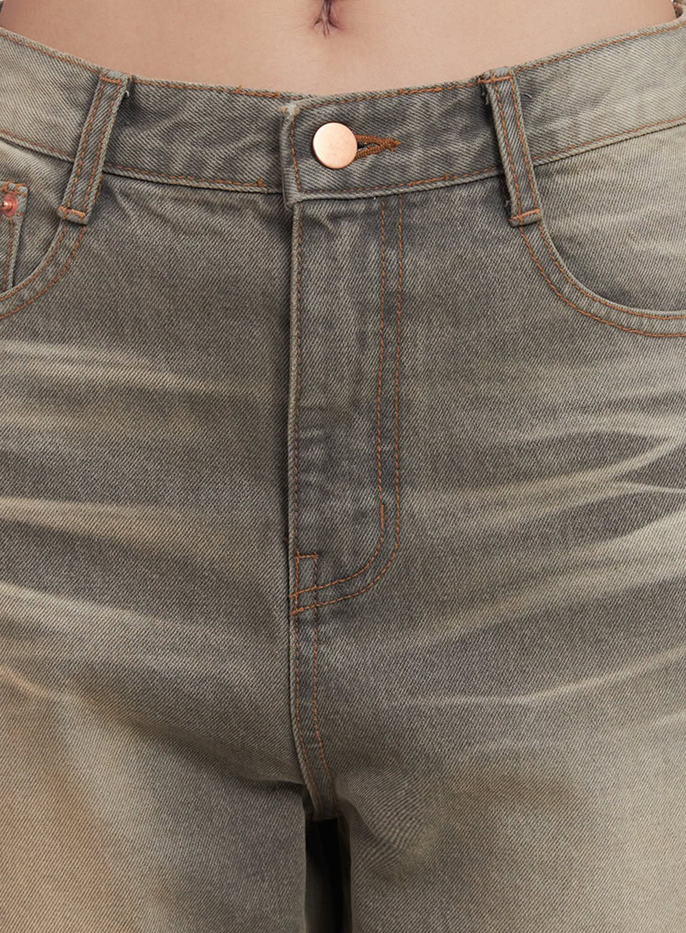 Sherry Washed Slim-Fit Bootcut Jeans IM528 in vintage brown, close-up detail of waistband and fly, showing copper button, orange contrast topstitching, and coin pocket on washed cotton denim.