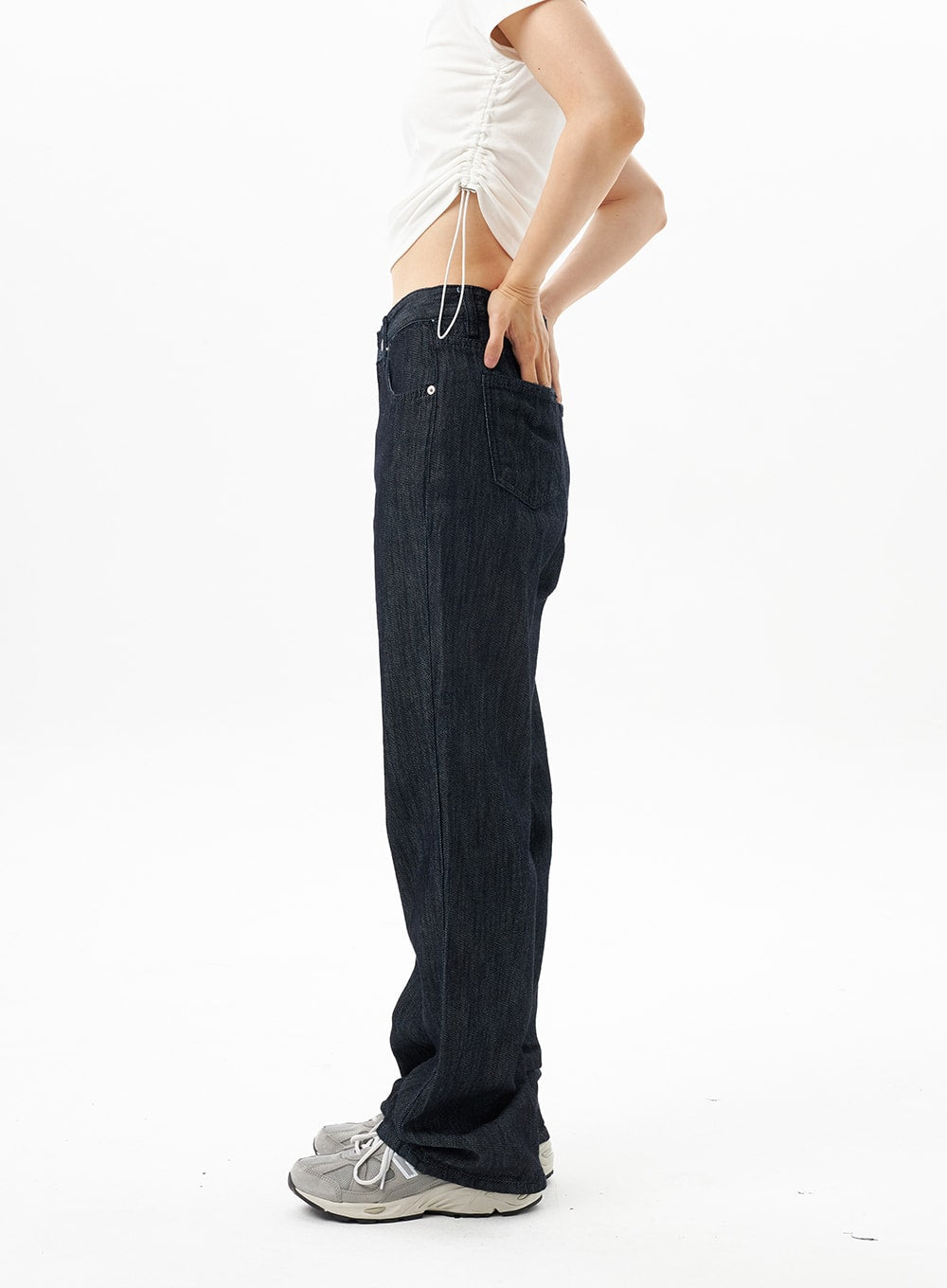 Dark Wash Mid-Rise Jeans OU314 in dark blue, side view close-up on model, bootcut leg silhouette from hip to floor, side pocket detail, dark indigo cotton denim texture.